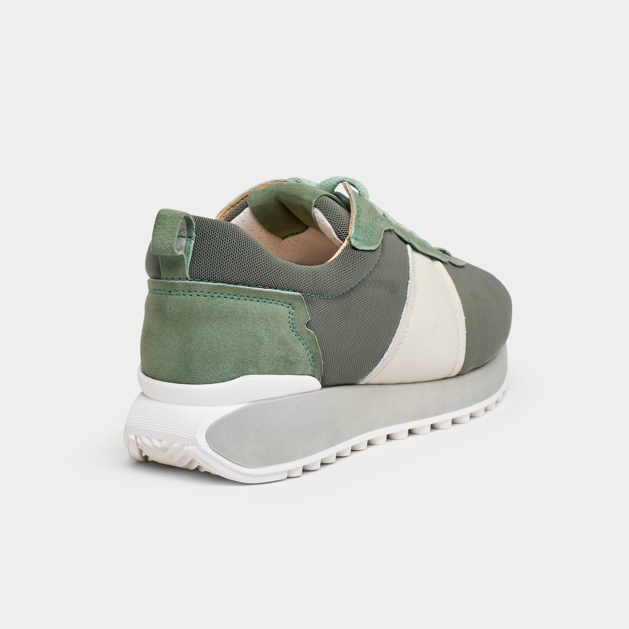 cosmos mist sneaker with white sole on a light gray background heel close-up