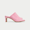 Pink suede mule shoe on a light gray background