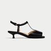 Black sandal with a strap on a white background