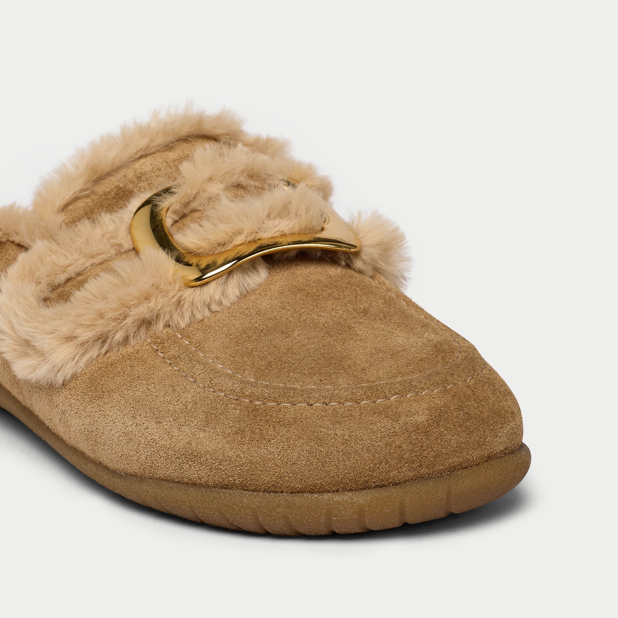 Tan slipper with gold buckle on a light gray background