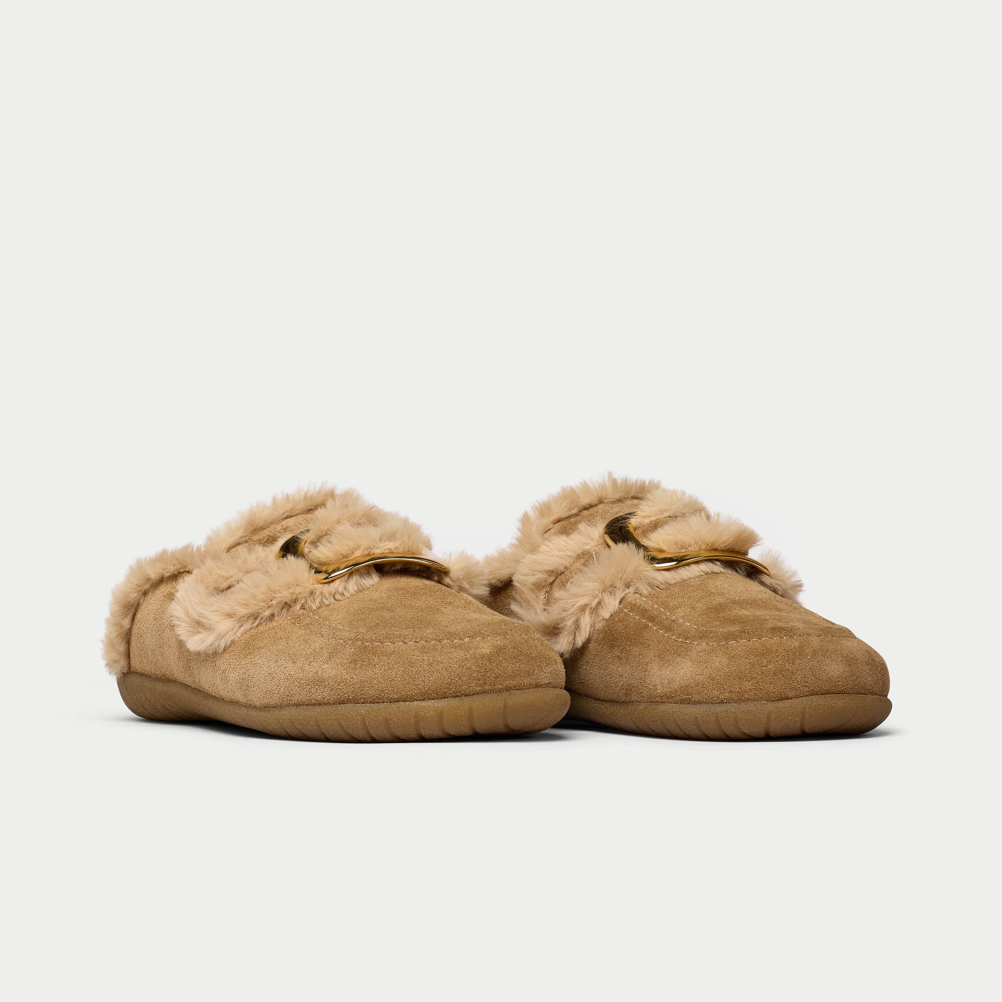 Pair of brown slippers with fuzzy trim on a light gray background