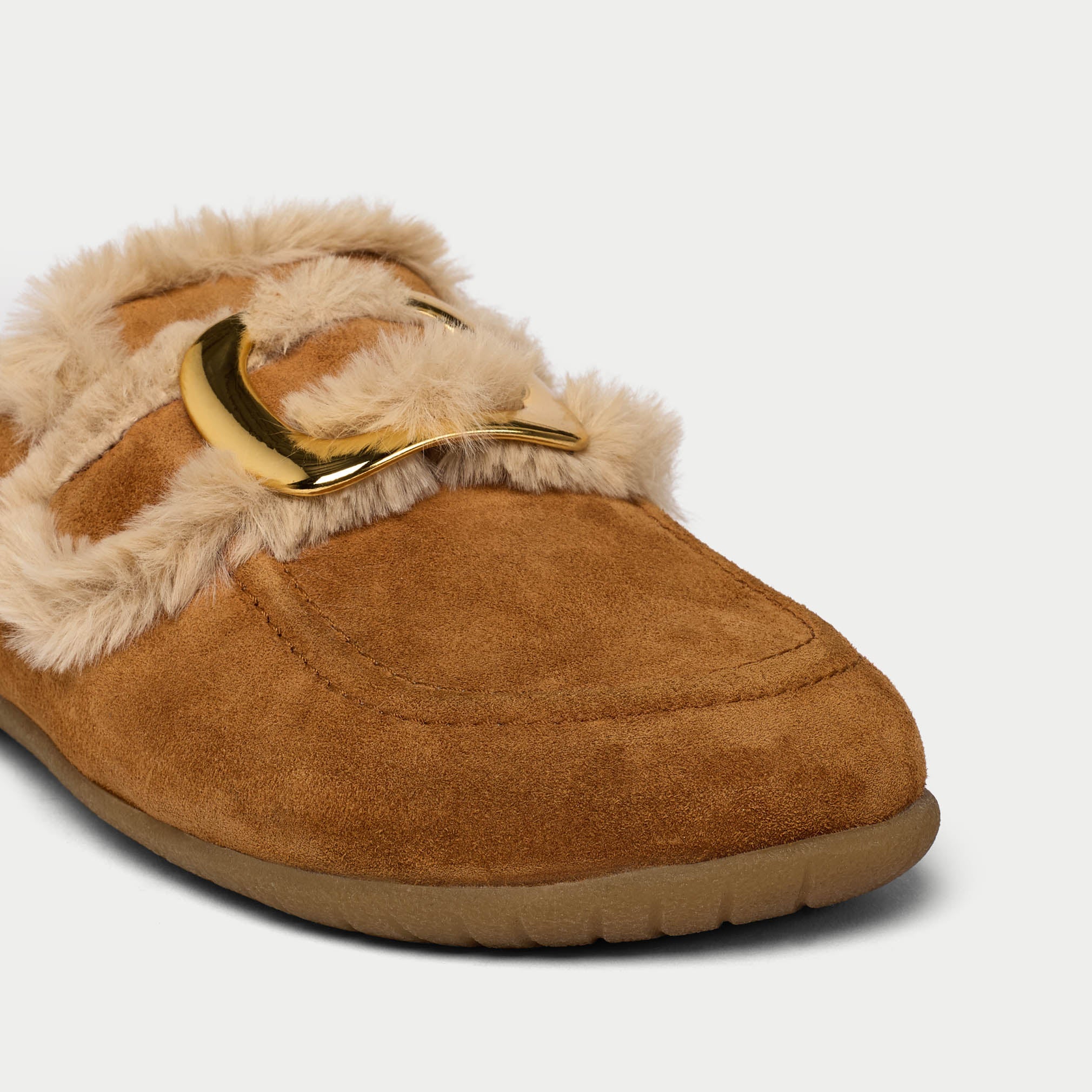 Brown slipper with fur trim and gold buckle on a white background