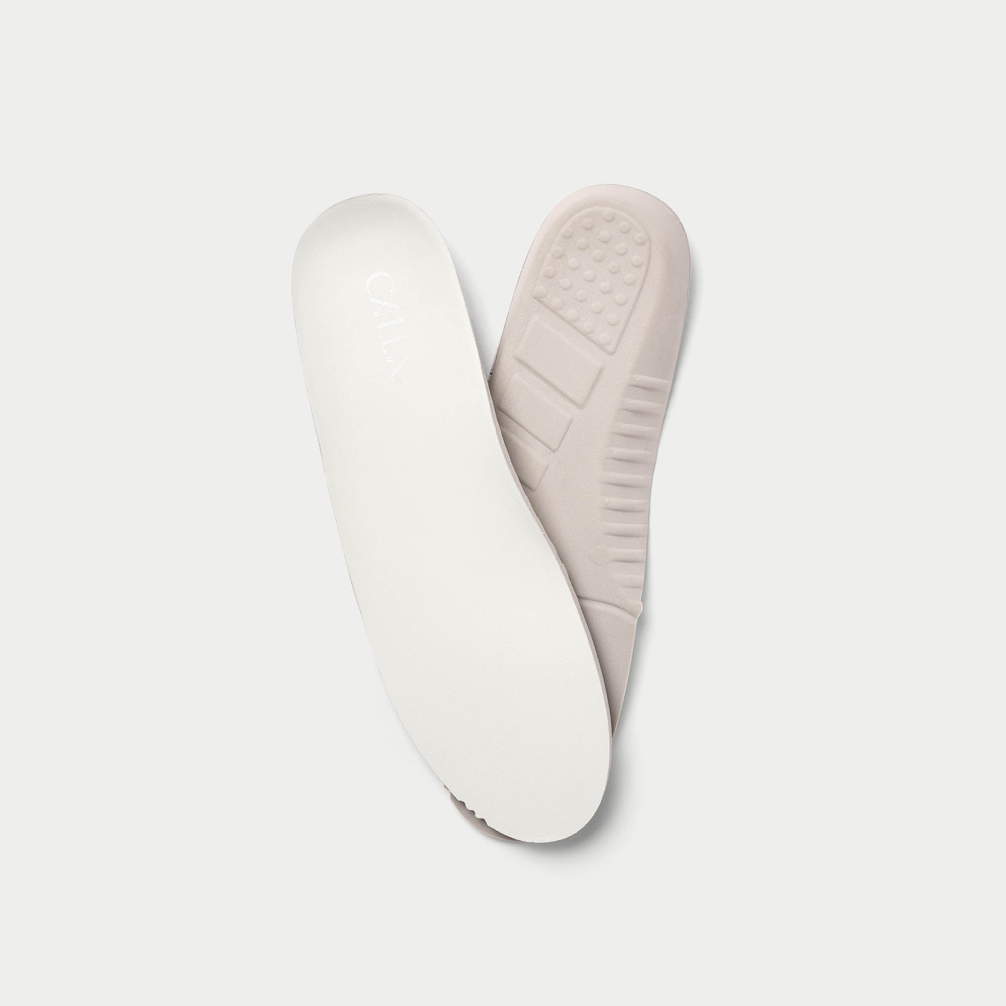 White shoe insoles on a light gray background