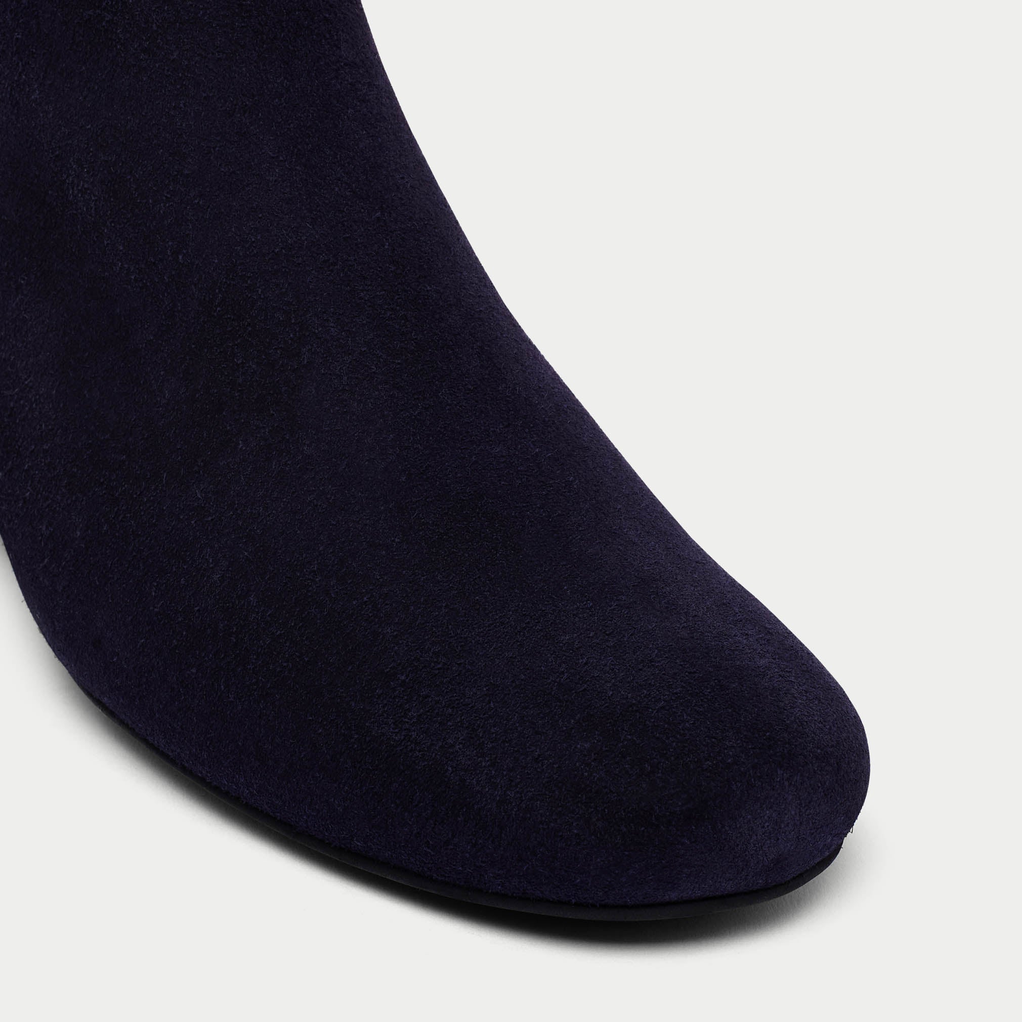 navy lexie suede boot on white background tip close up