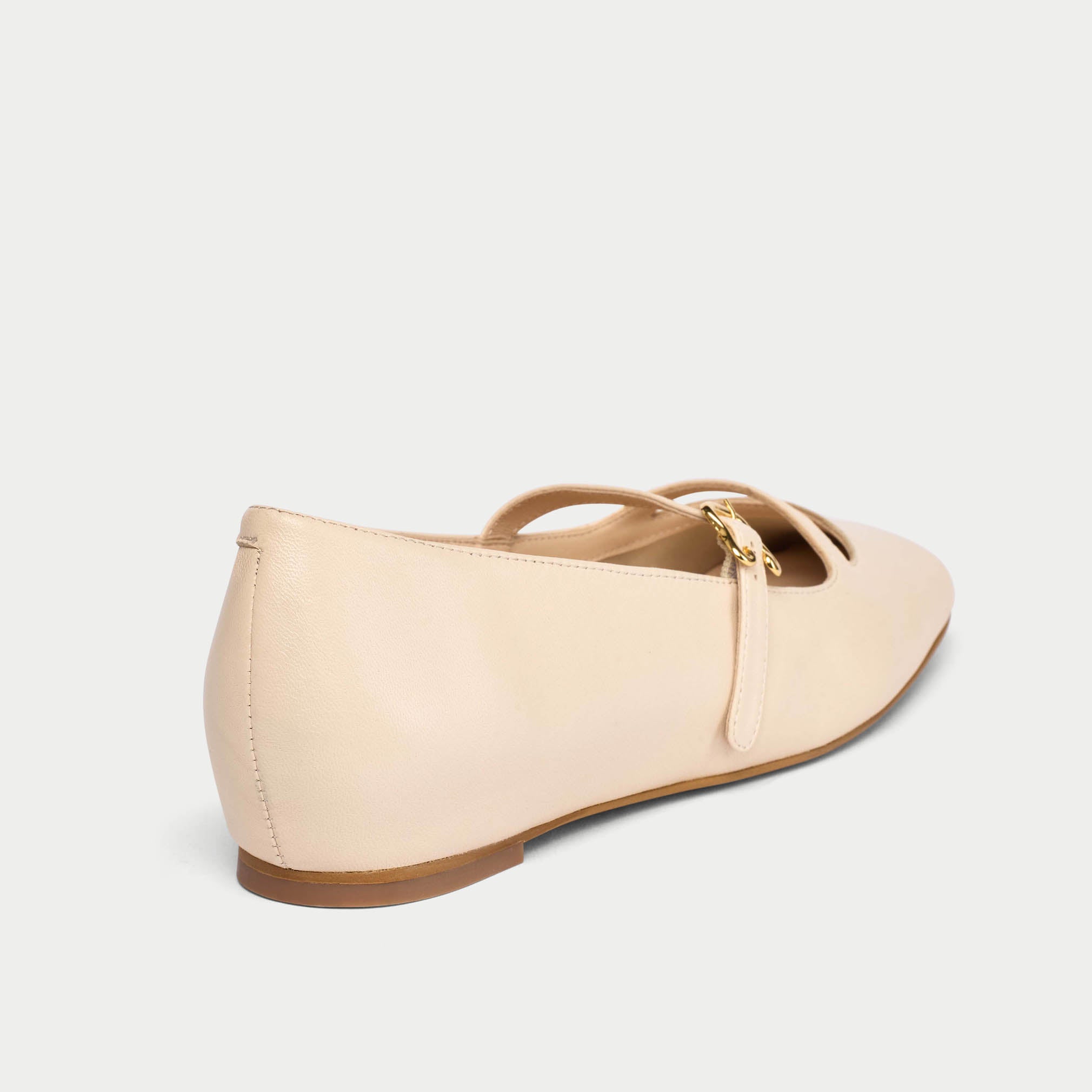 Beige flat shoe on a light gray background
