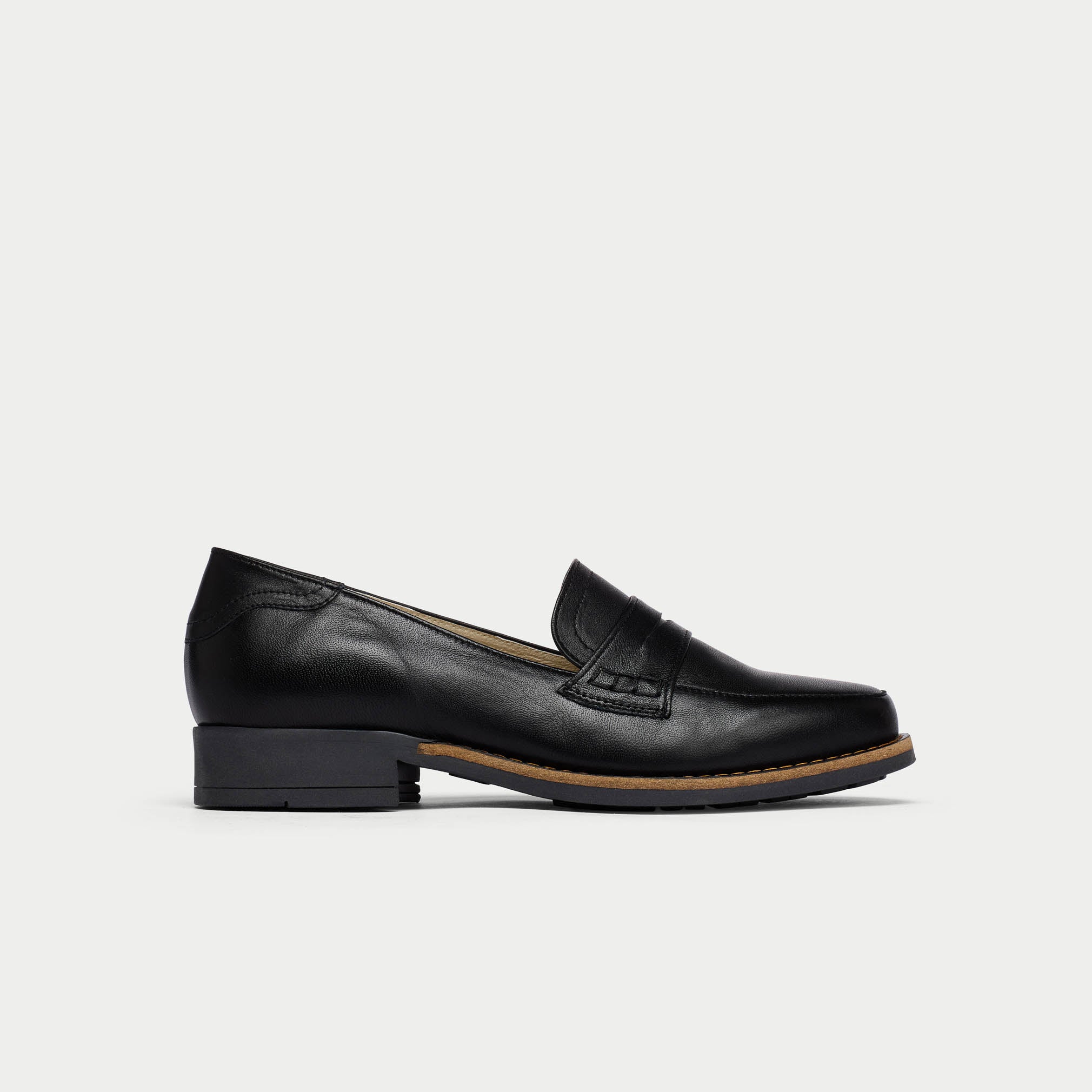 Black loafer shoe on a light gray background