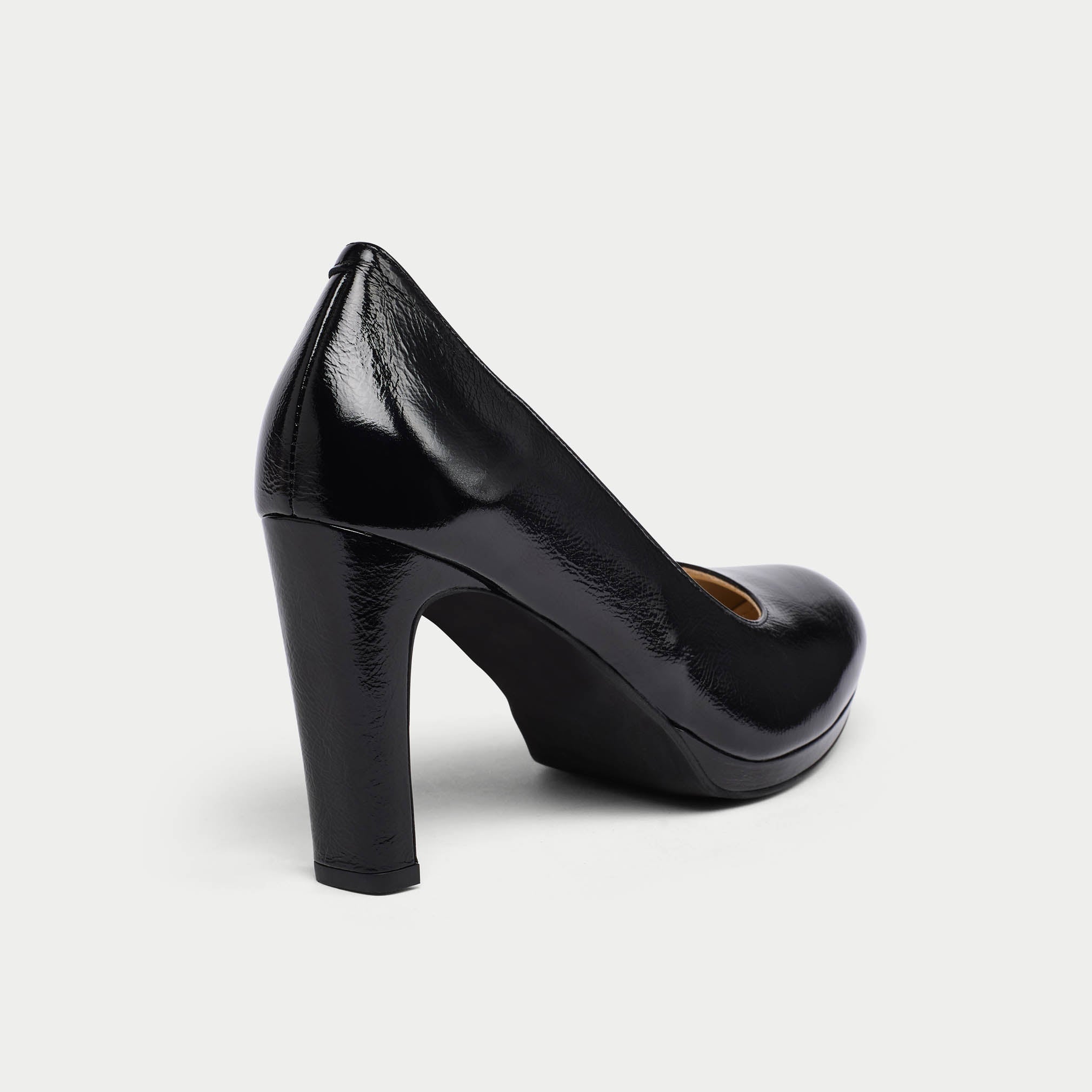 Black high-heeled shoe on a light gray background