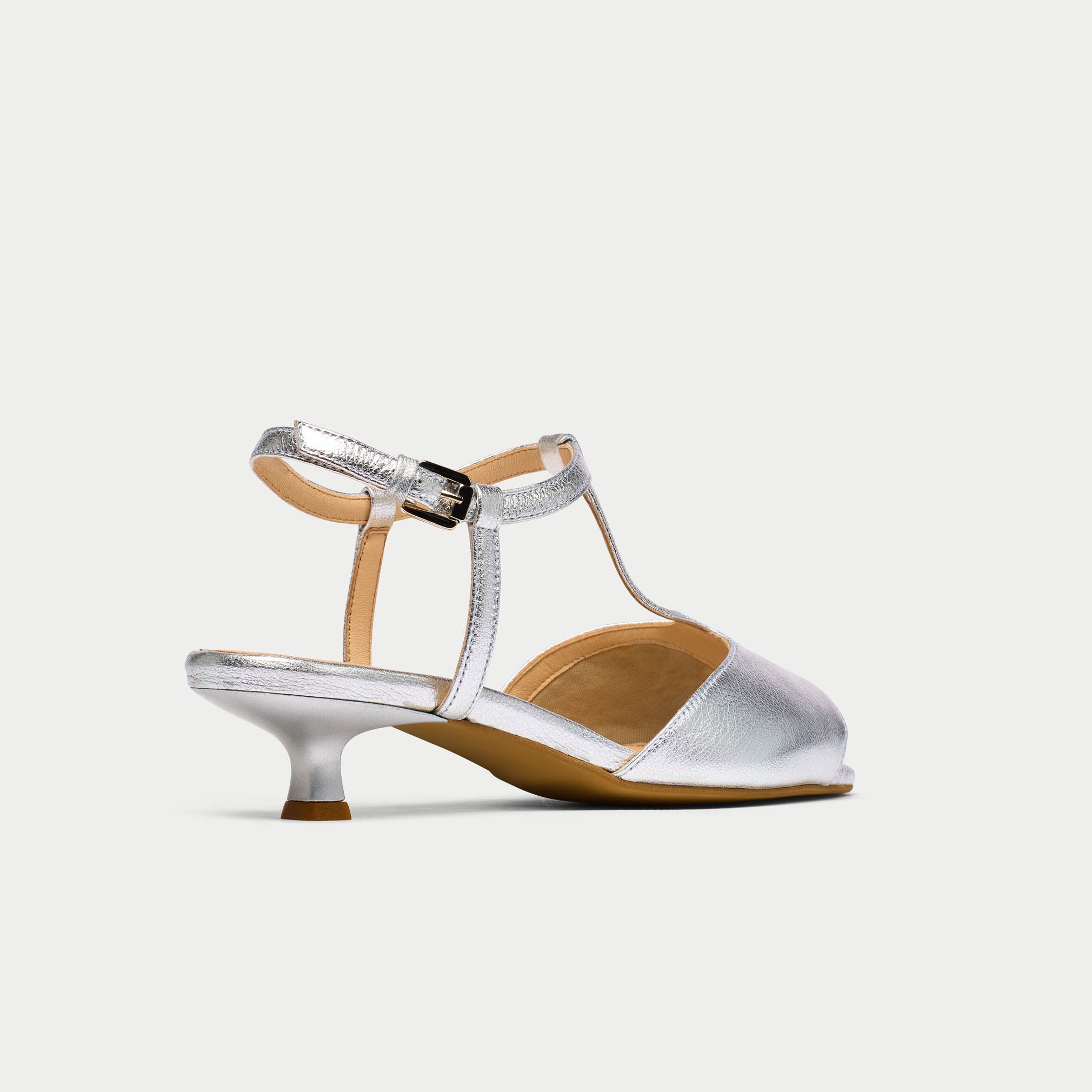 Silver high-heeled shoe on a white background