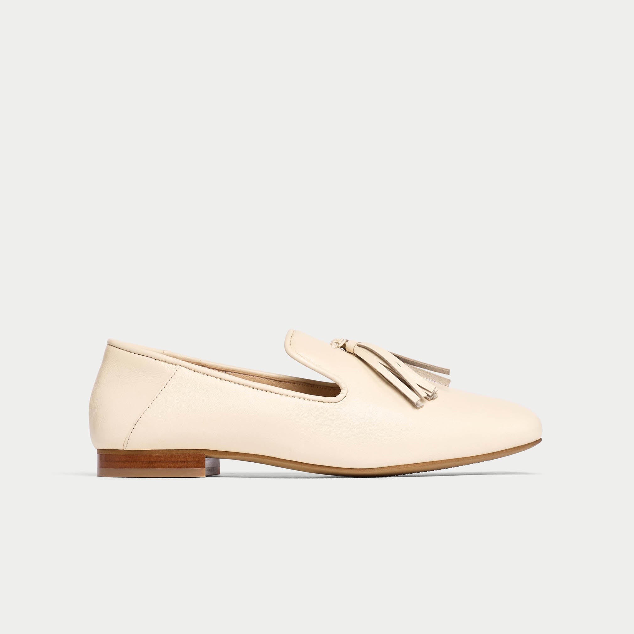 Beige loafer shoe on a light gray background
