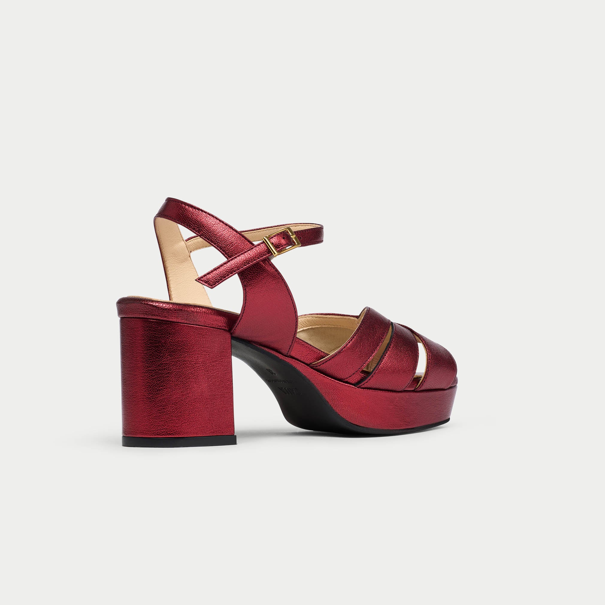 Red high-heeled shoe on a light gray background
