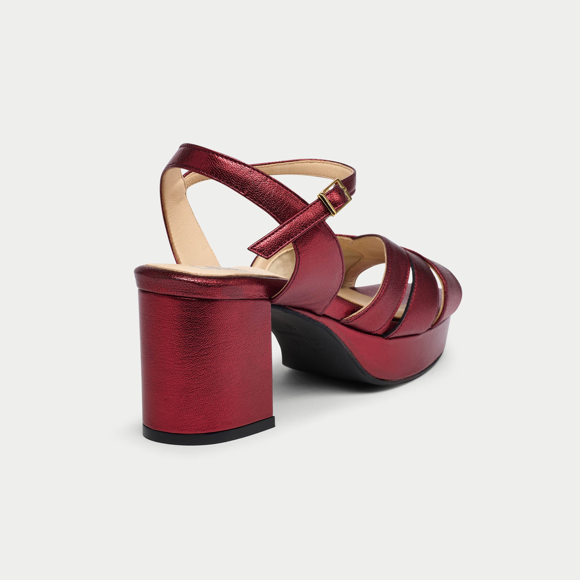 Red high-heeled shoe on a light gray background