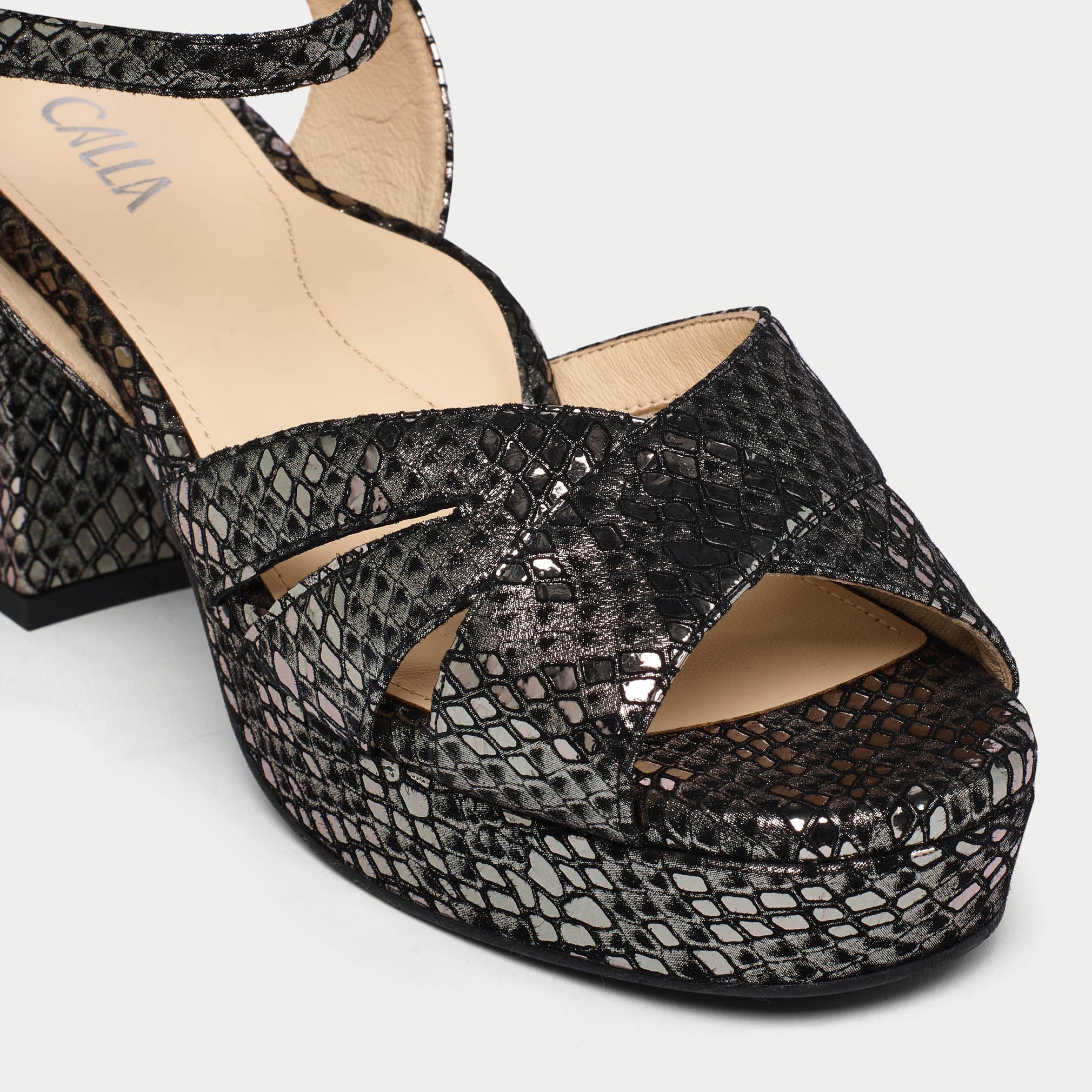 Black snake print sandal with open toe on a white background
