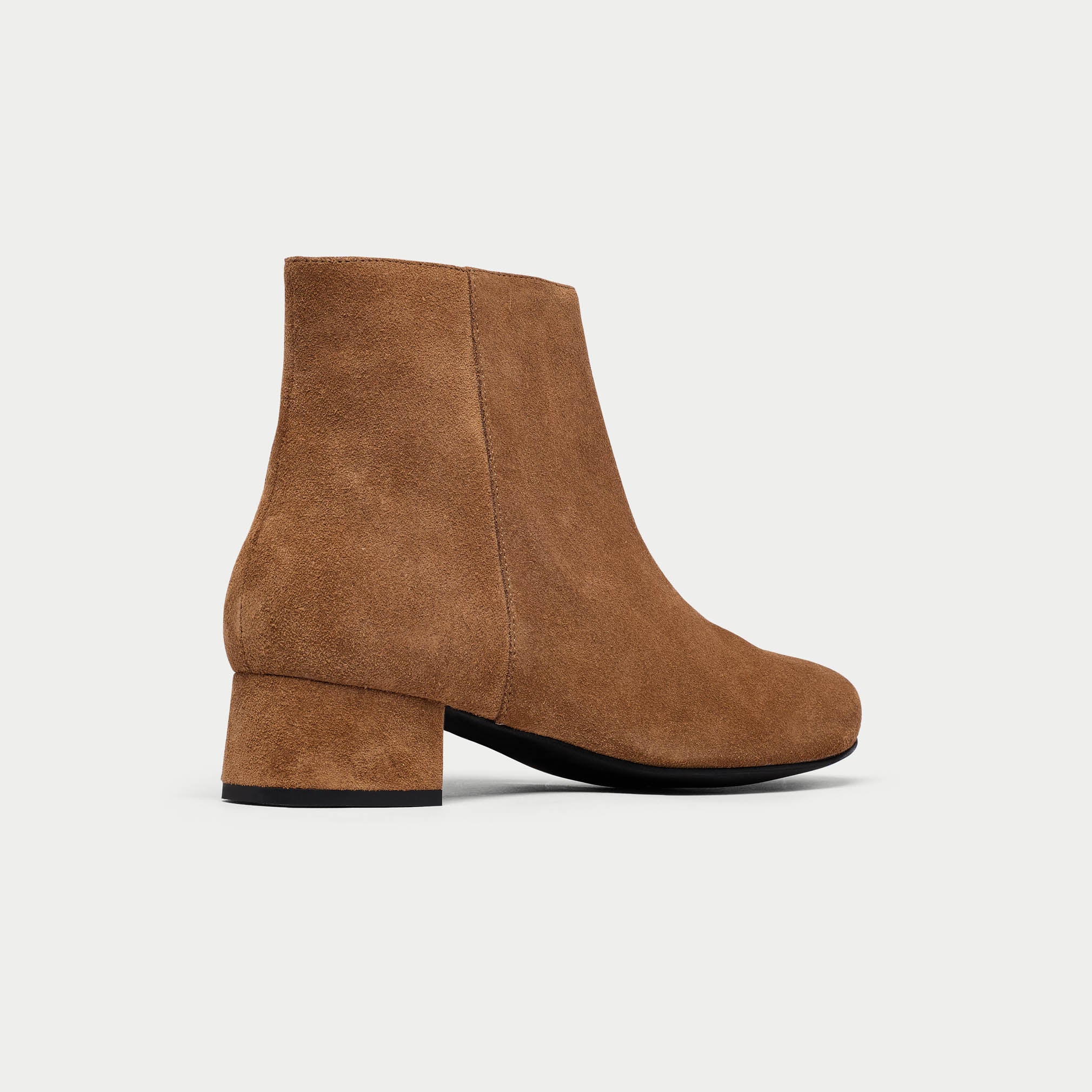 Brown suede ankle boot on a light gray background