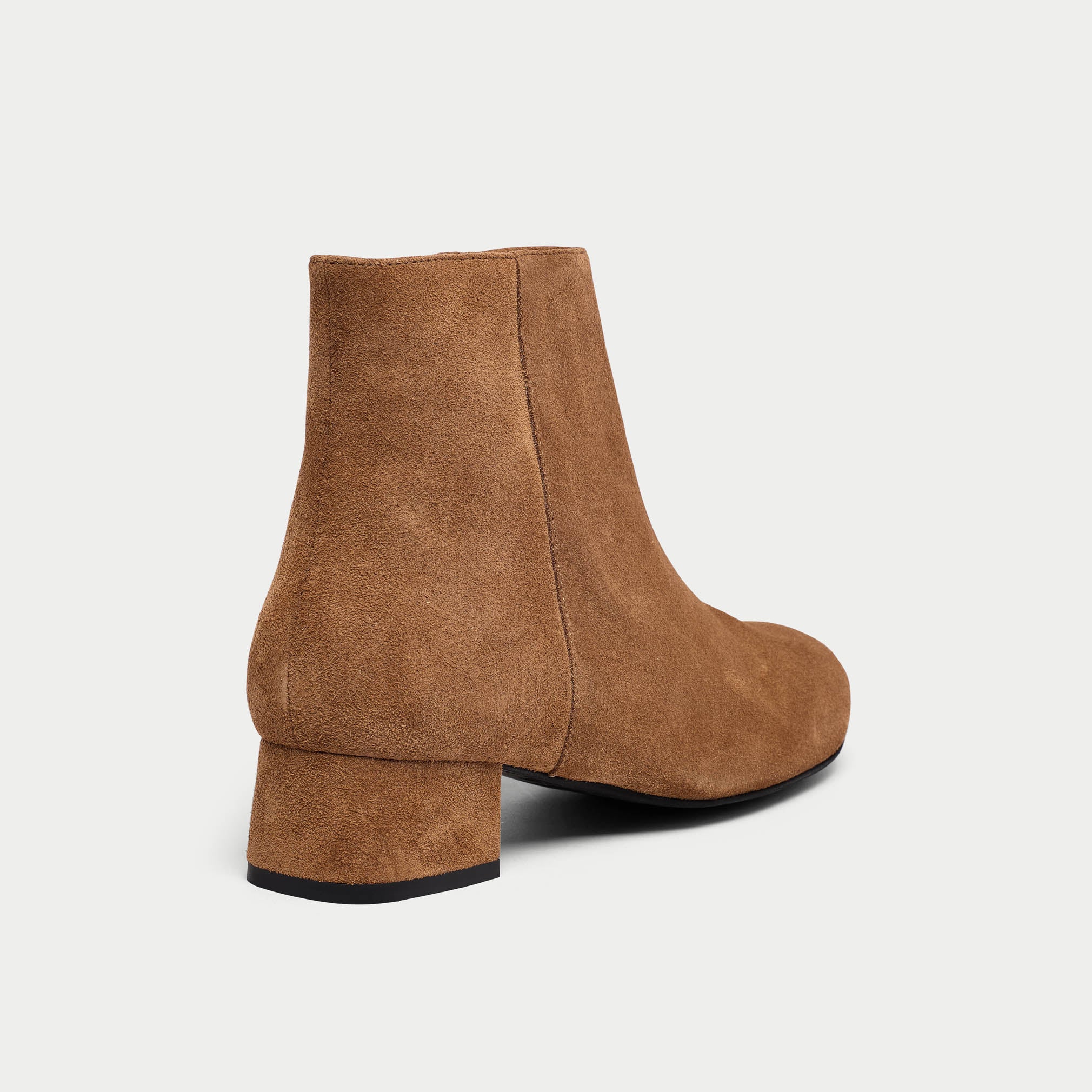 Brown suede ankle boot on a light gray background