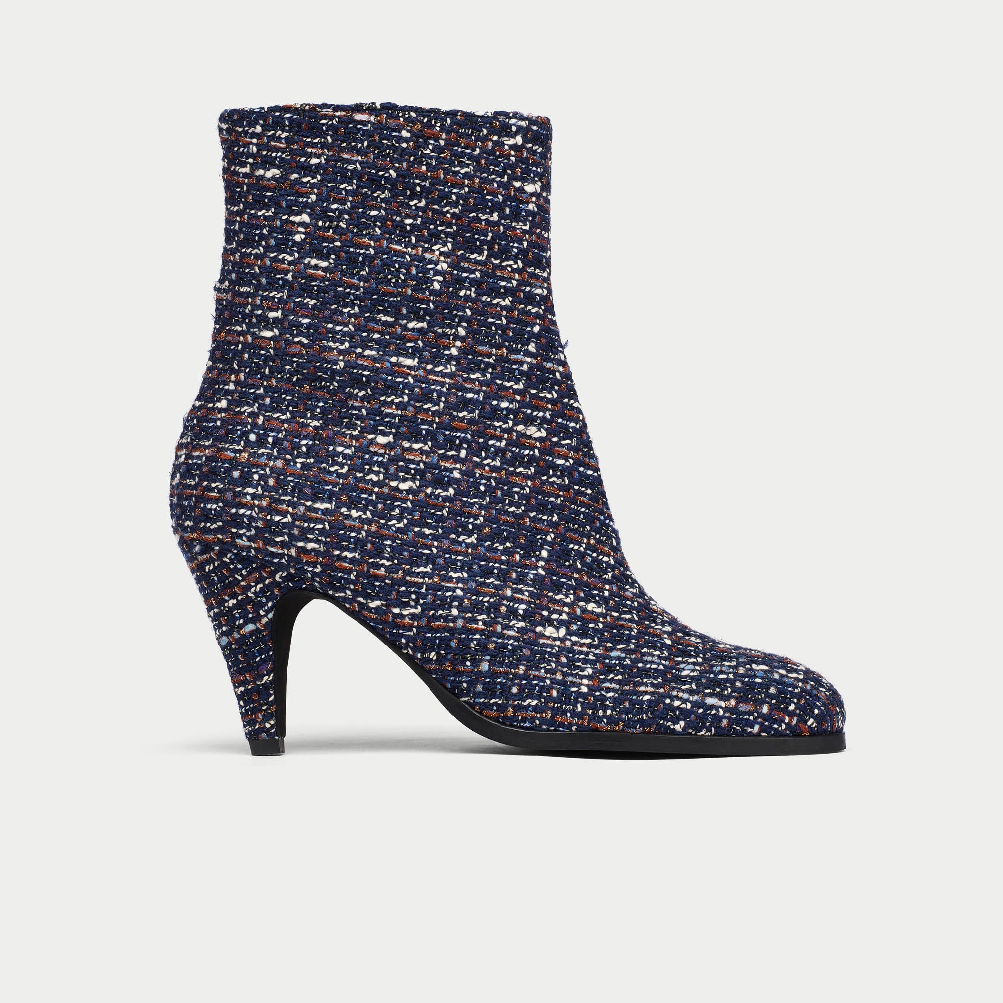Navy blue tweed ankle boot on a light gray background