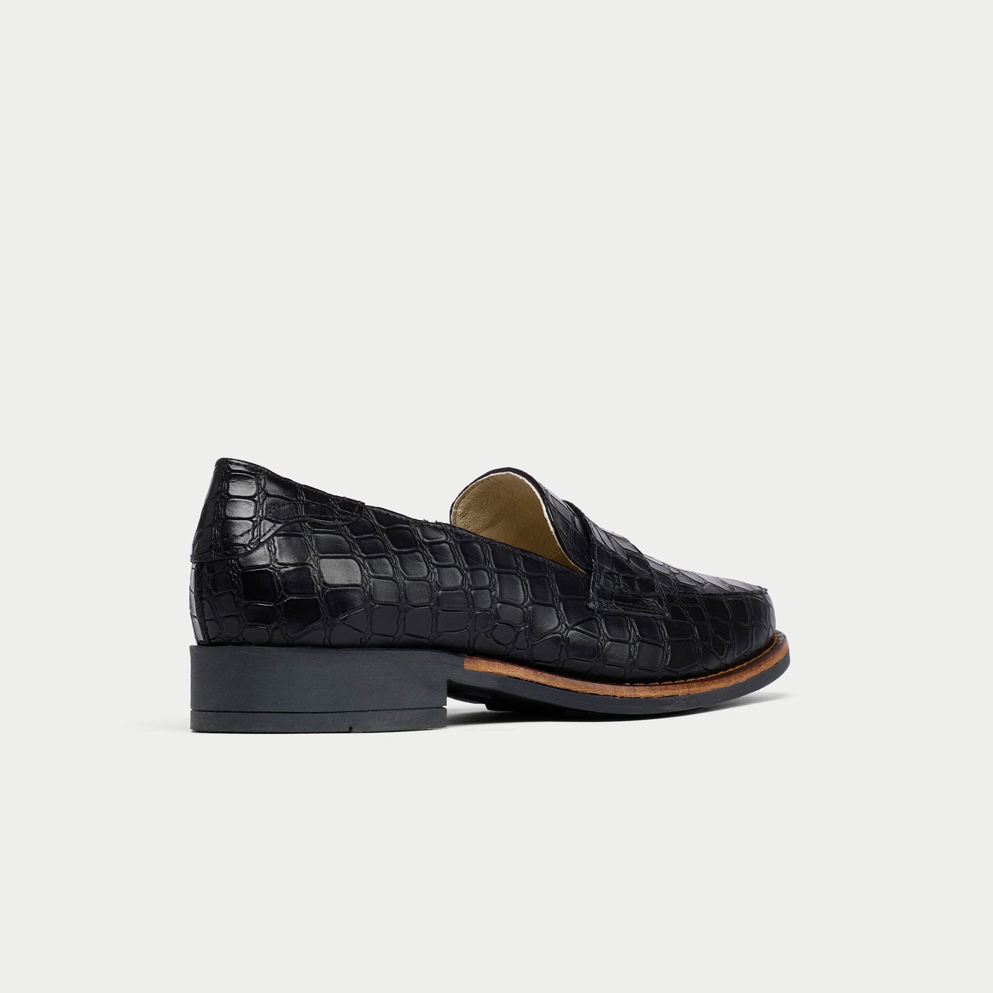 Black Nadia crocodile-patterned loafer on a light gray background