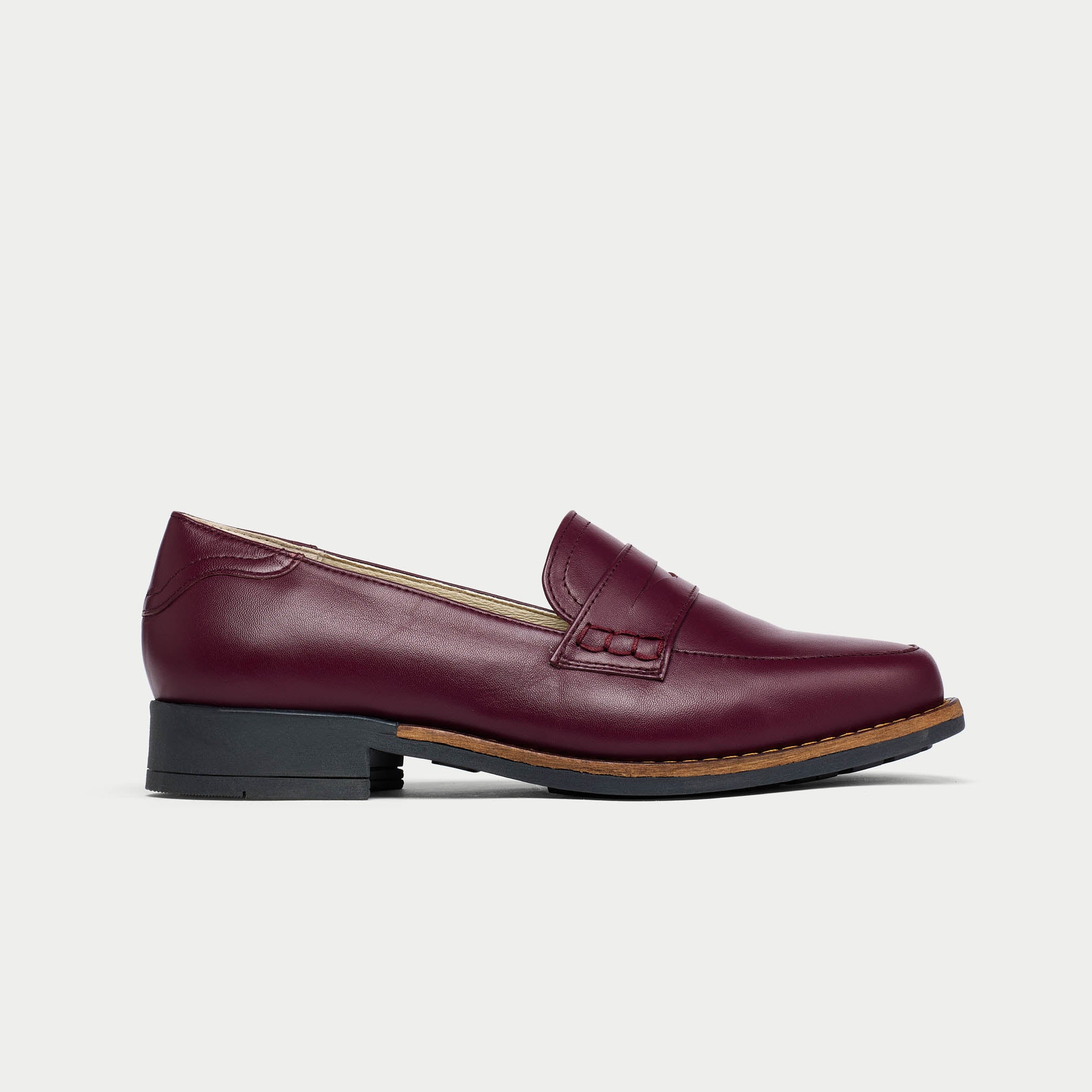 Burgundy loafer shoe on a light gray background