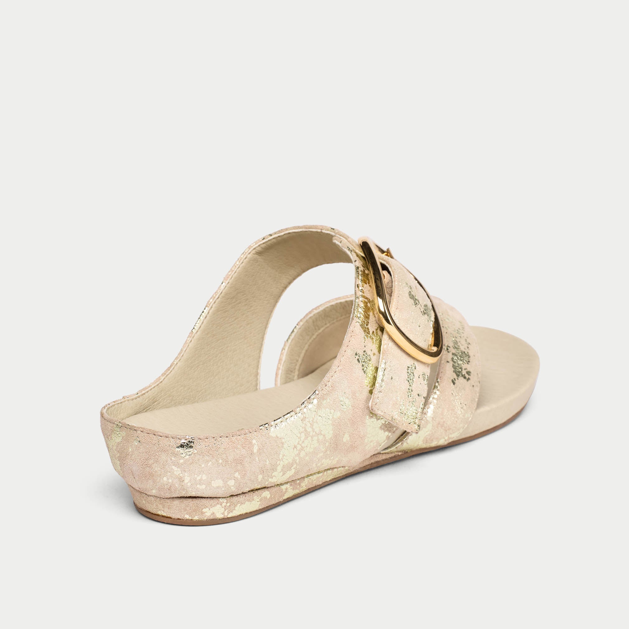 Beige sandal with a gold buckle on a light gray background