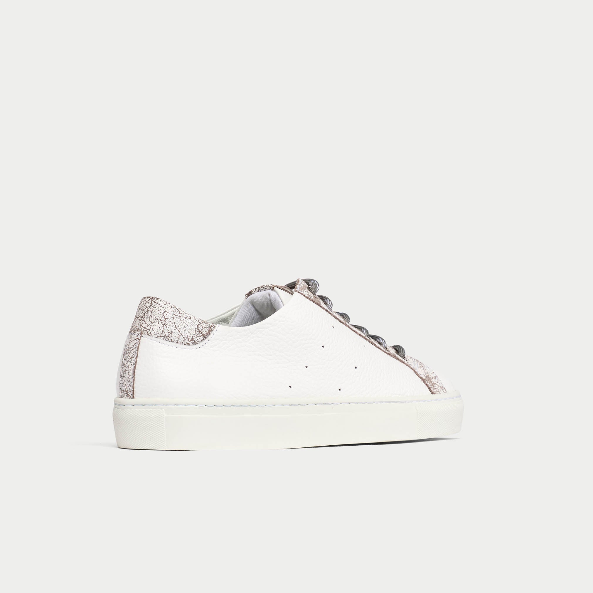 White sneaker with grey details on a light gray background