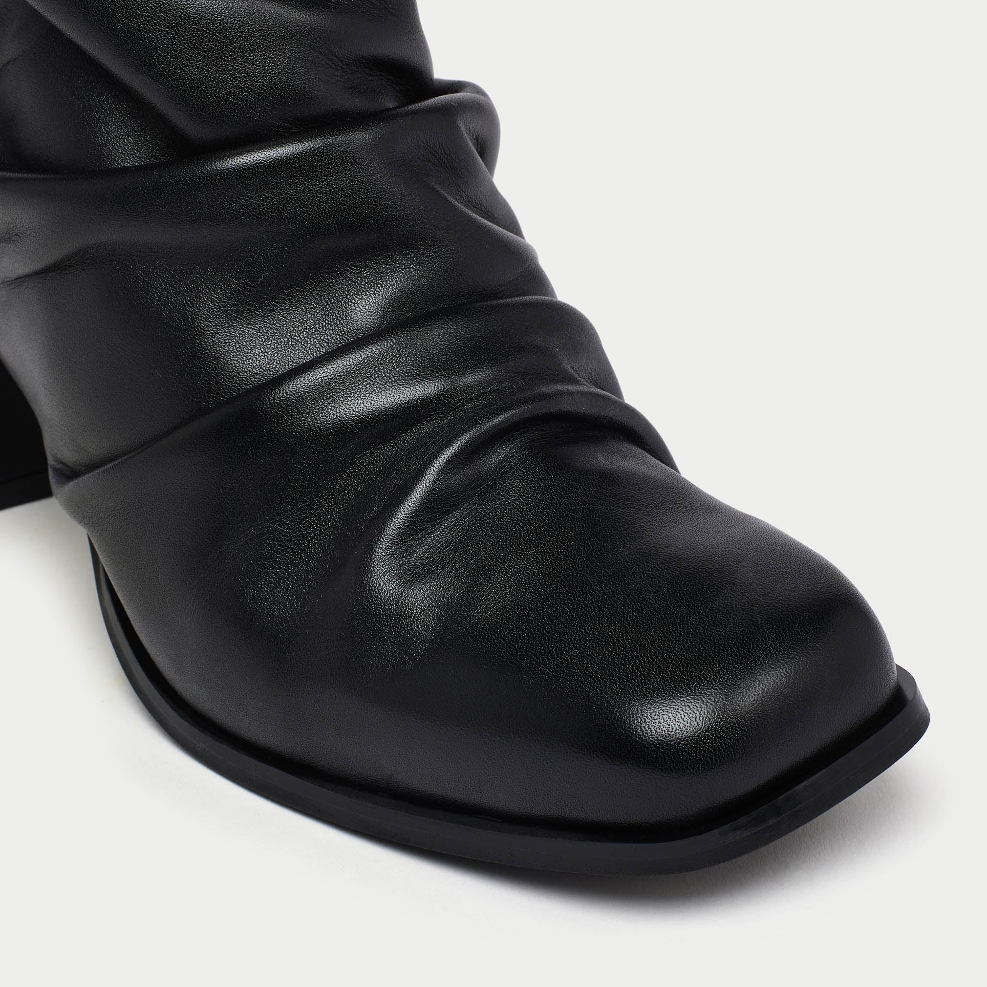 Black leather boot on a white background