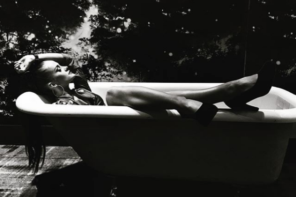 woman in a bathtub showing off her heels