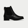 Black Chelsea boot on a light gray background