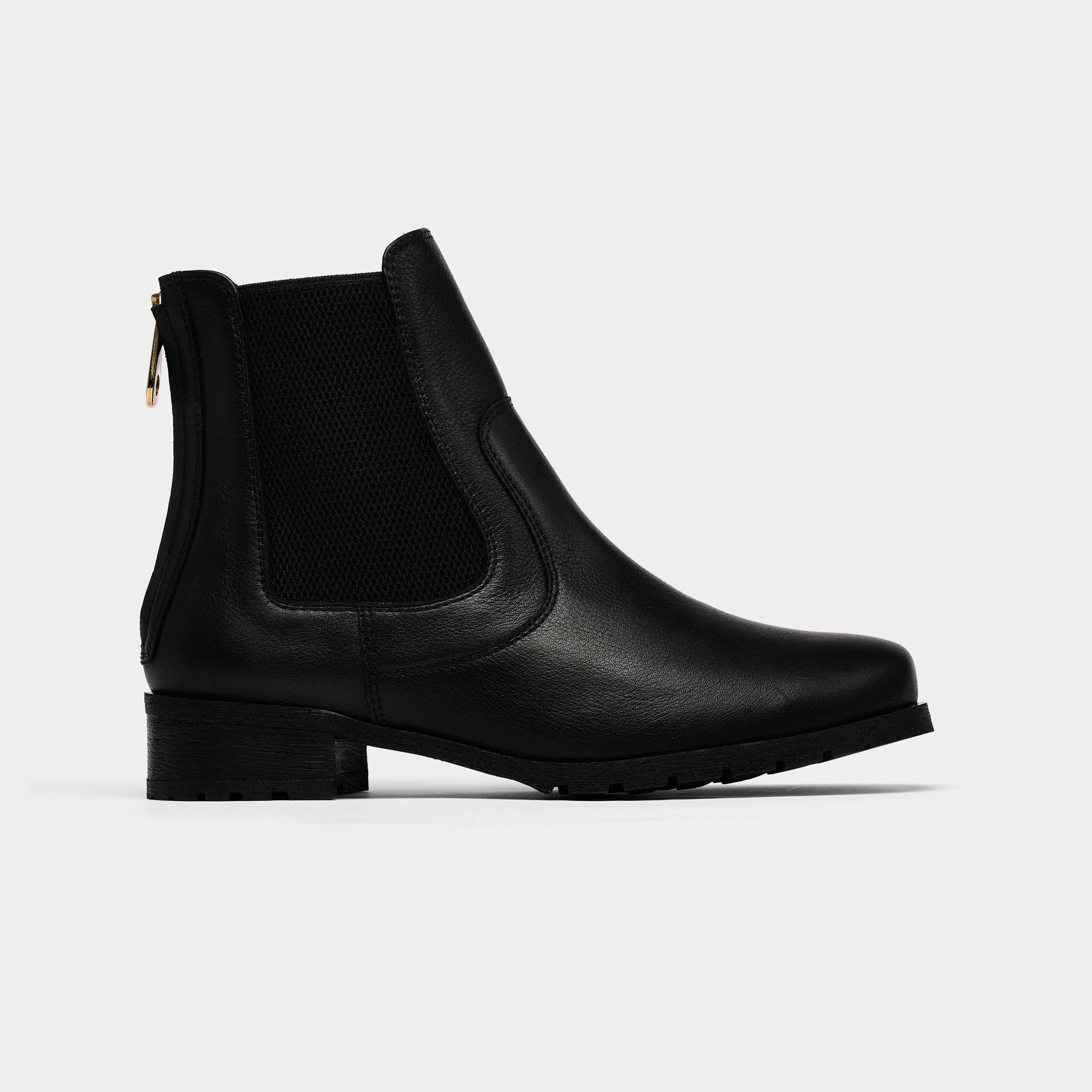 Black Chelsea boot on a light gray background