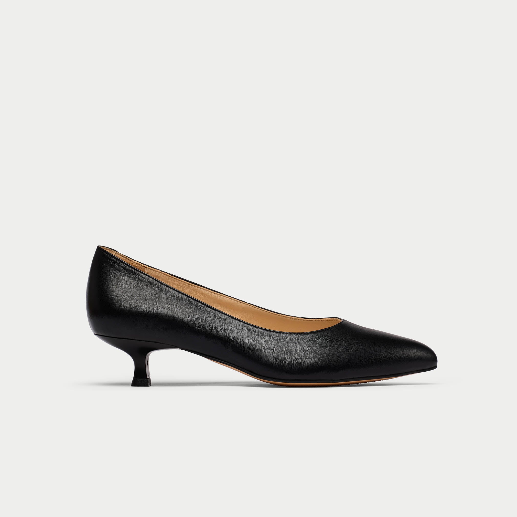 Black leather shoe on a light gray background