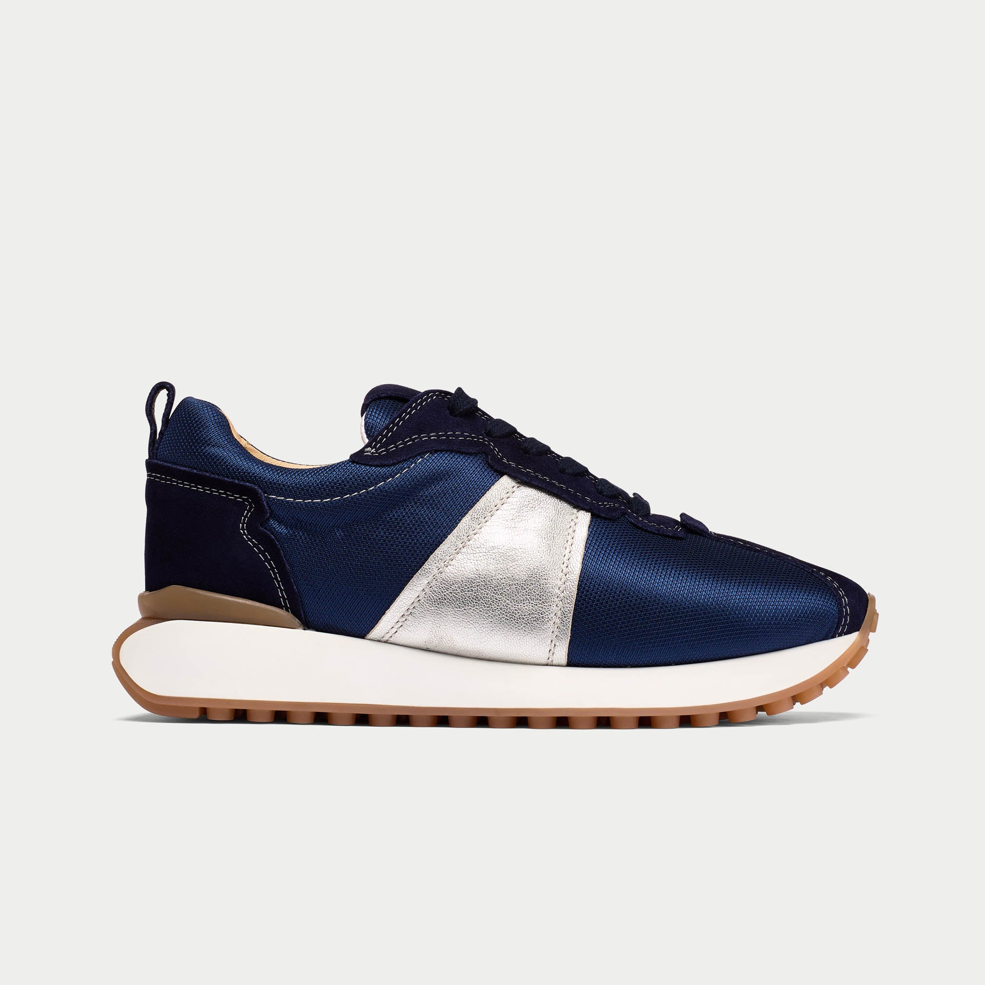 Navy and silver sneaker on a light gray background