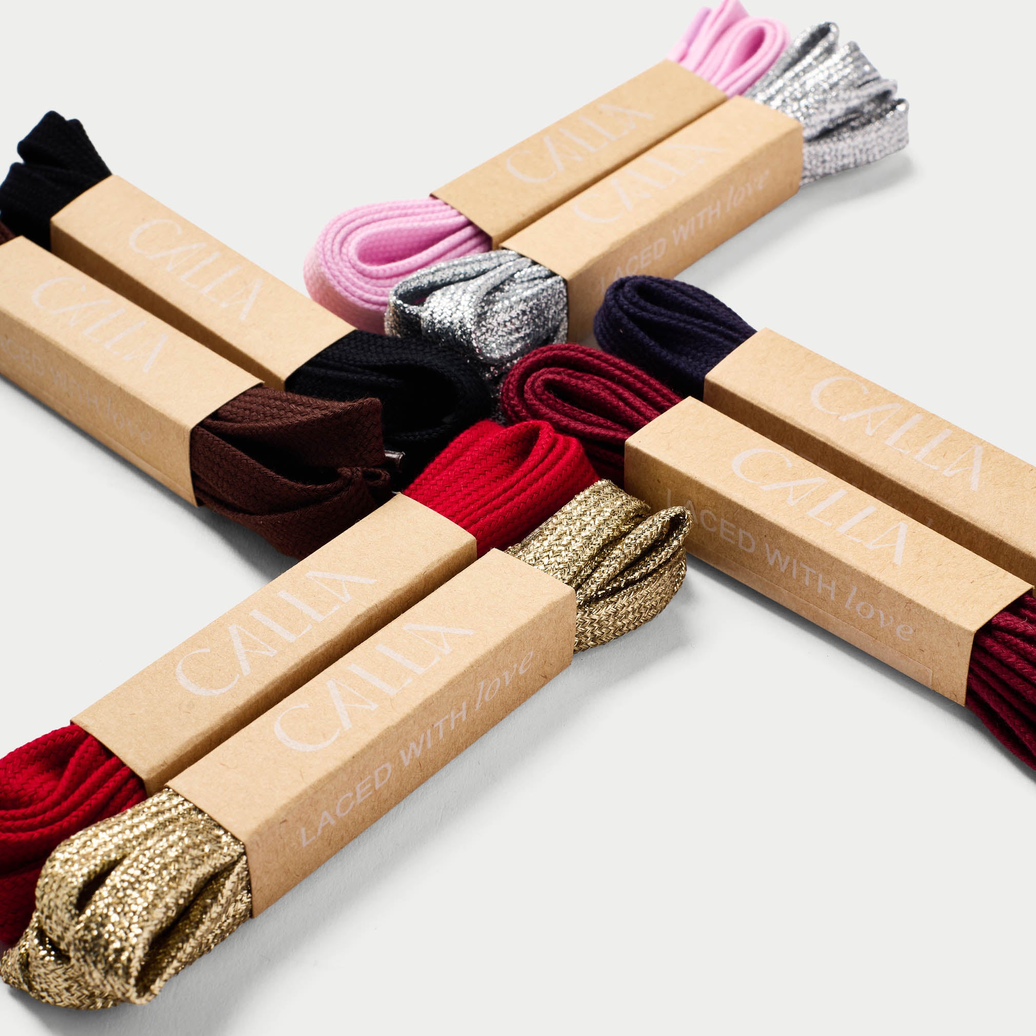 Packaged calla shoelaces with visible brand name on cardboard boxes against a white background
