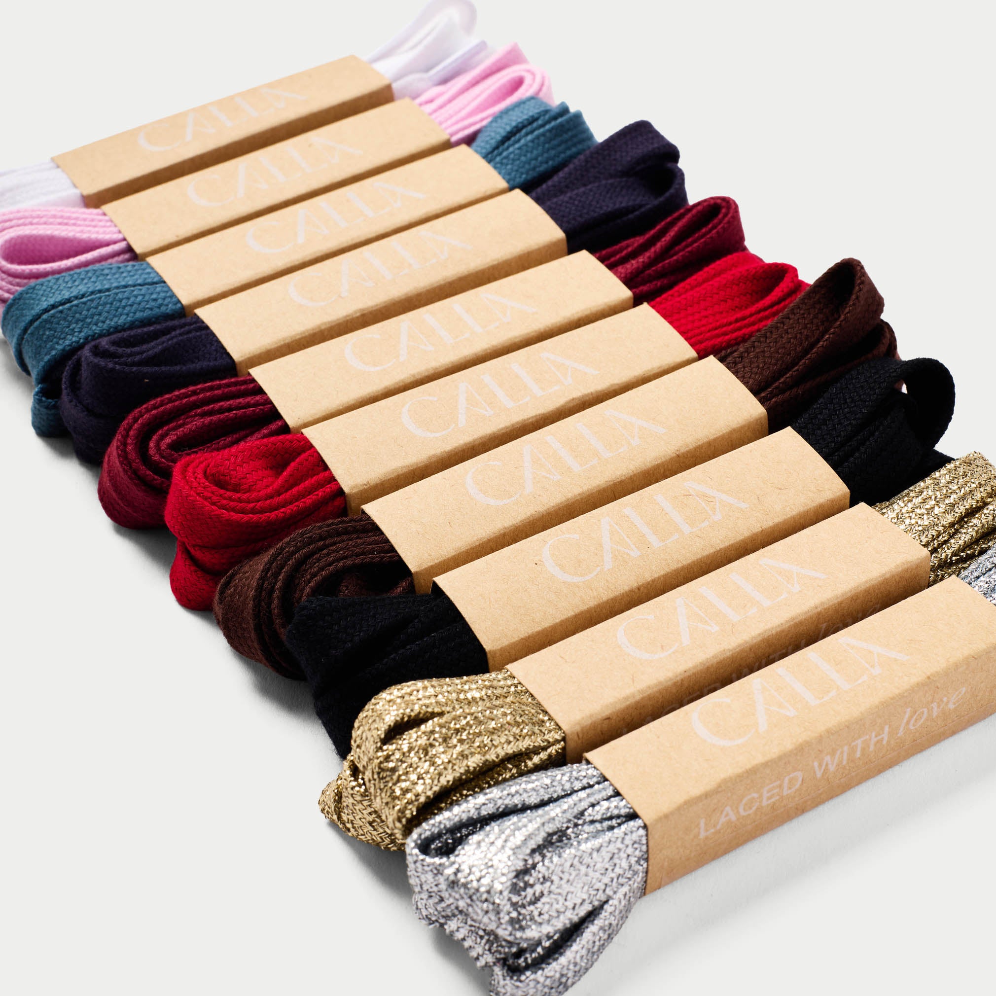 Calla shoelaces in various colors in cardboard boxes with Calla branding