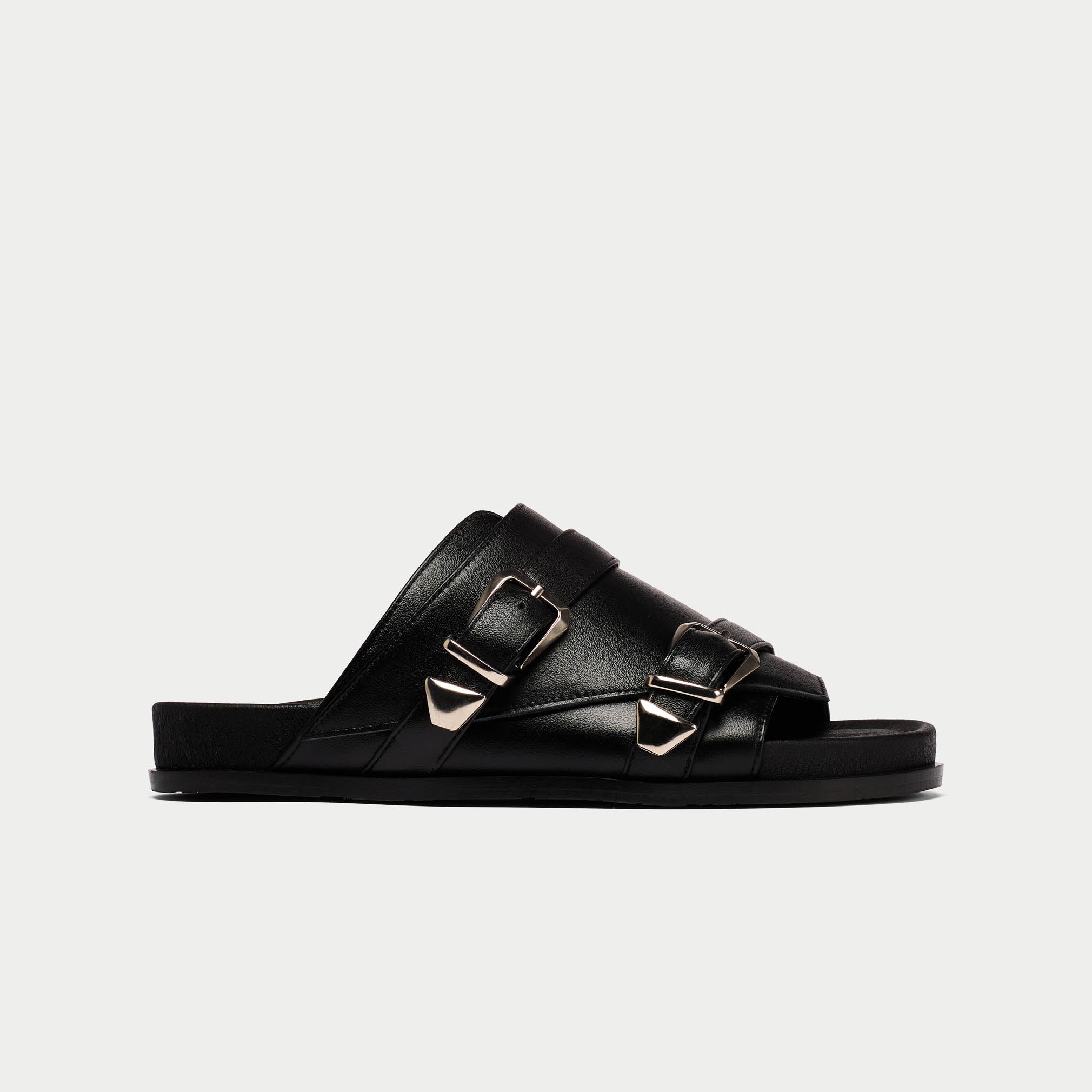 Black sandal with buckles on a light gray background