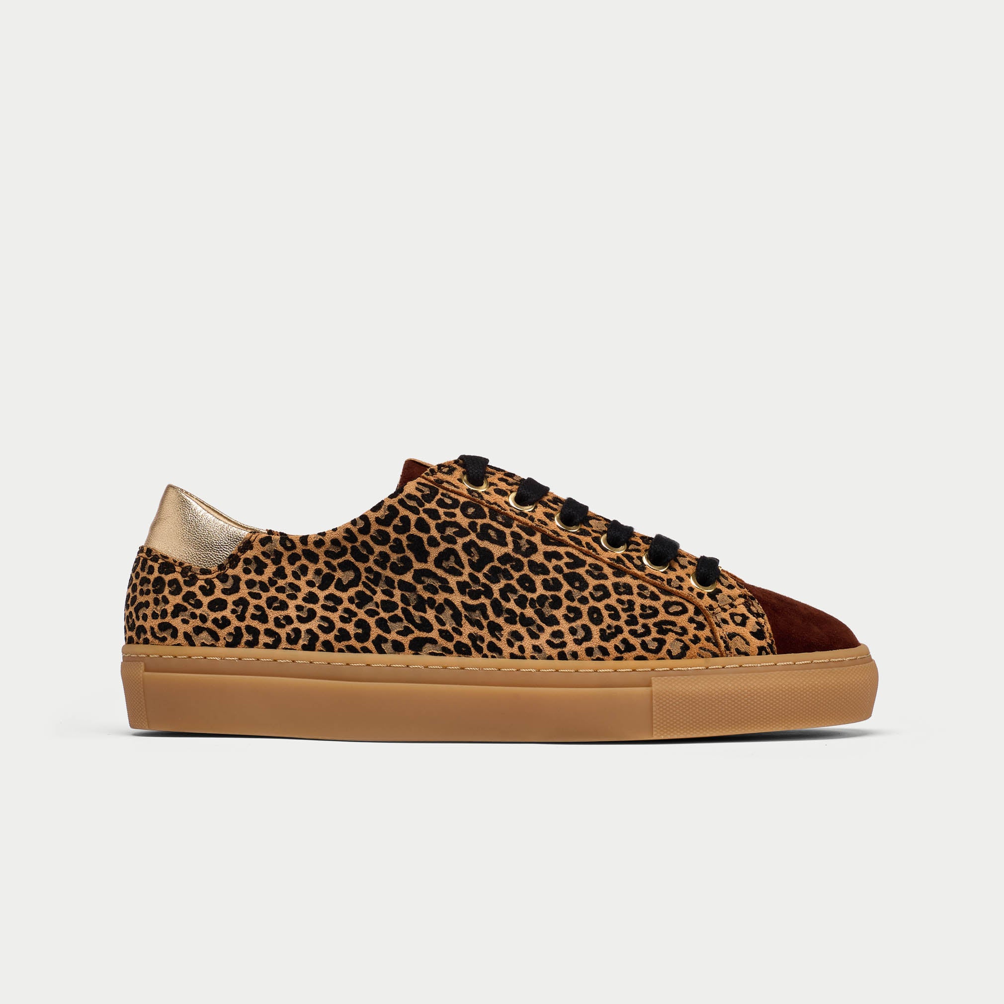 Leopard print sneaker with brown sole on a light gray background
