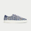 Blue and white sneaker with textured pattern on a light gray background