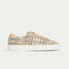 Textured sneaker with wooden beads on a light gray background