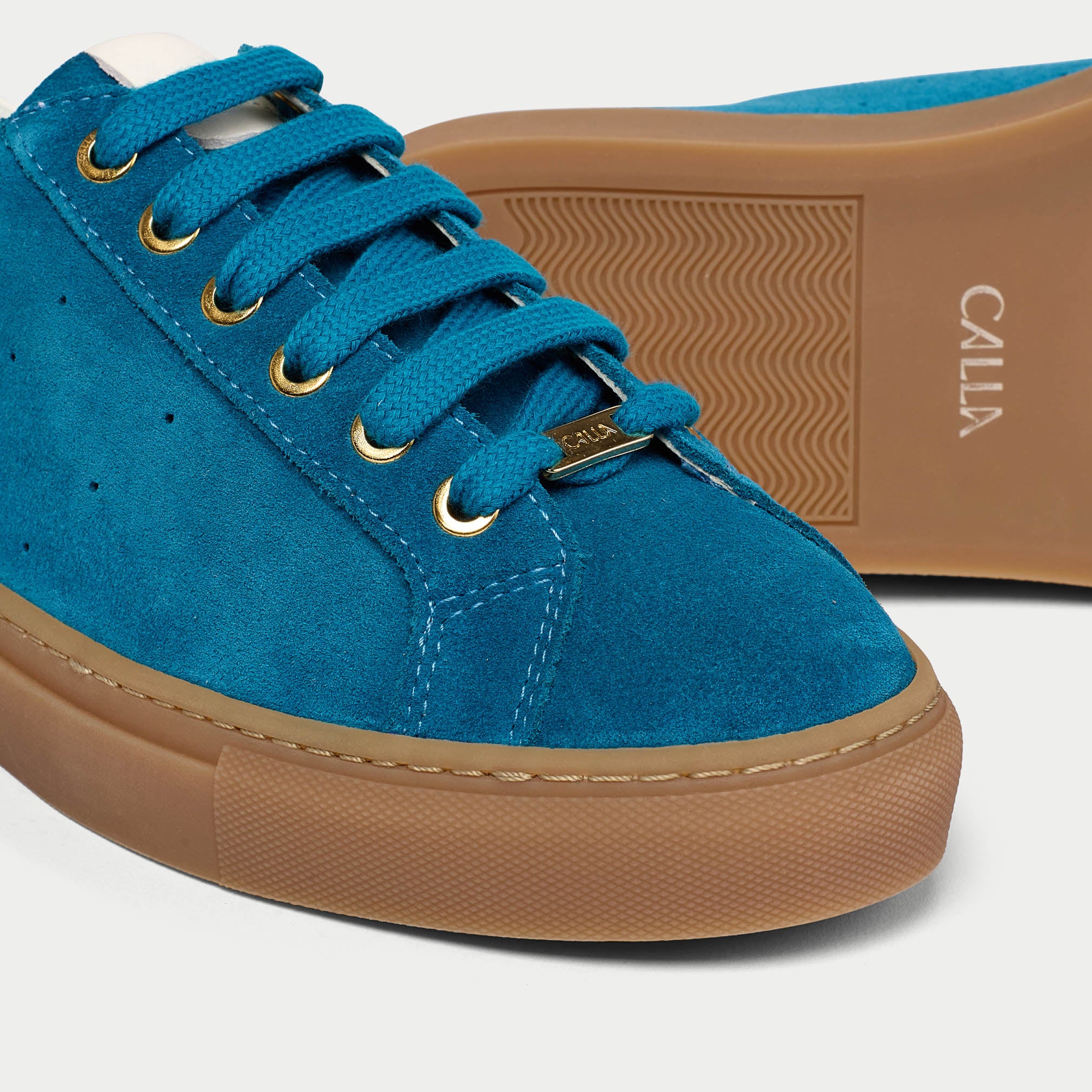 Star teal suede sneakers close-up tip view