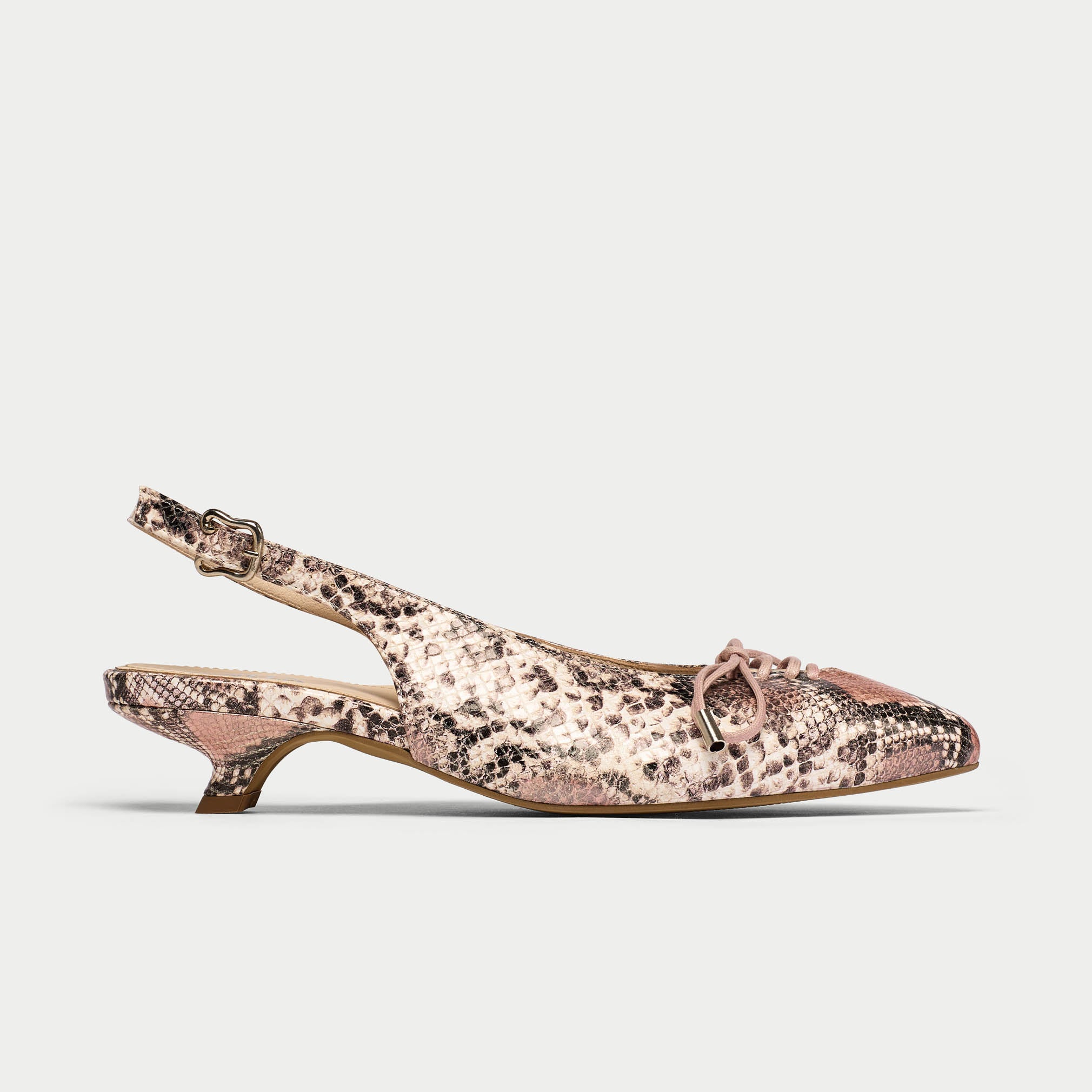 Slingback shoe with snake print and pink accents on a light gray background