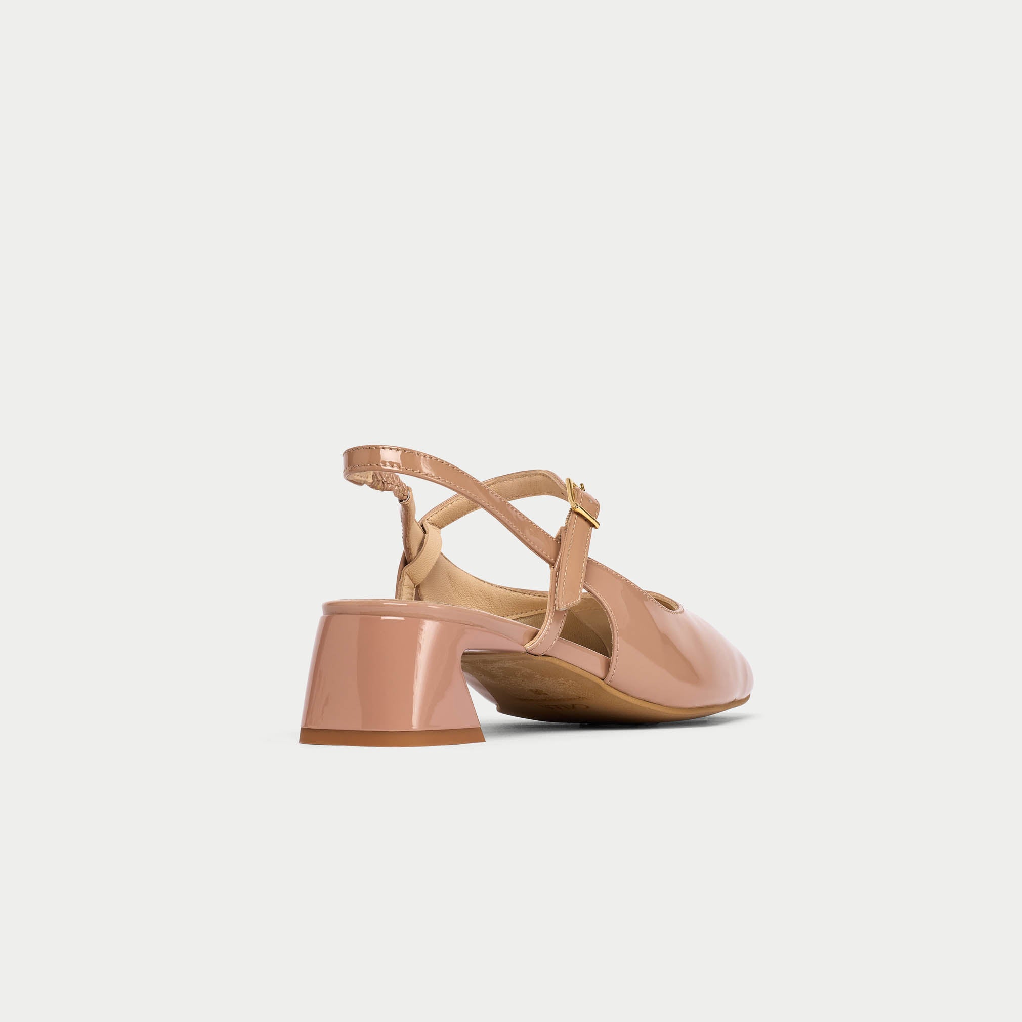 Pink sandal with a block heel on a light gray background