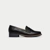 Black loafer shoe on a light gray background
