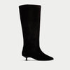 Black knee-high boot on a light gray background