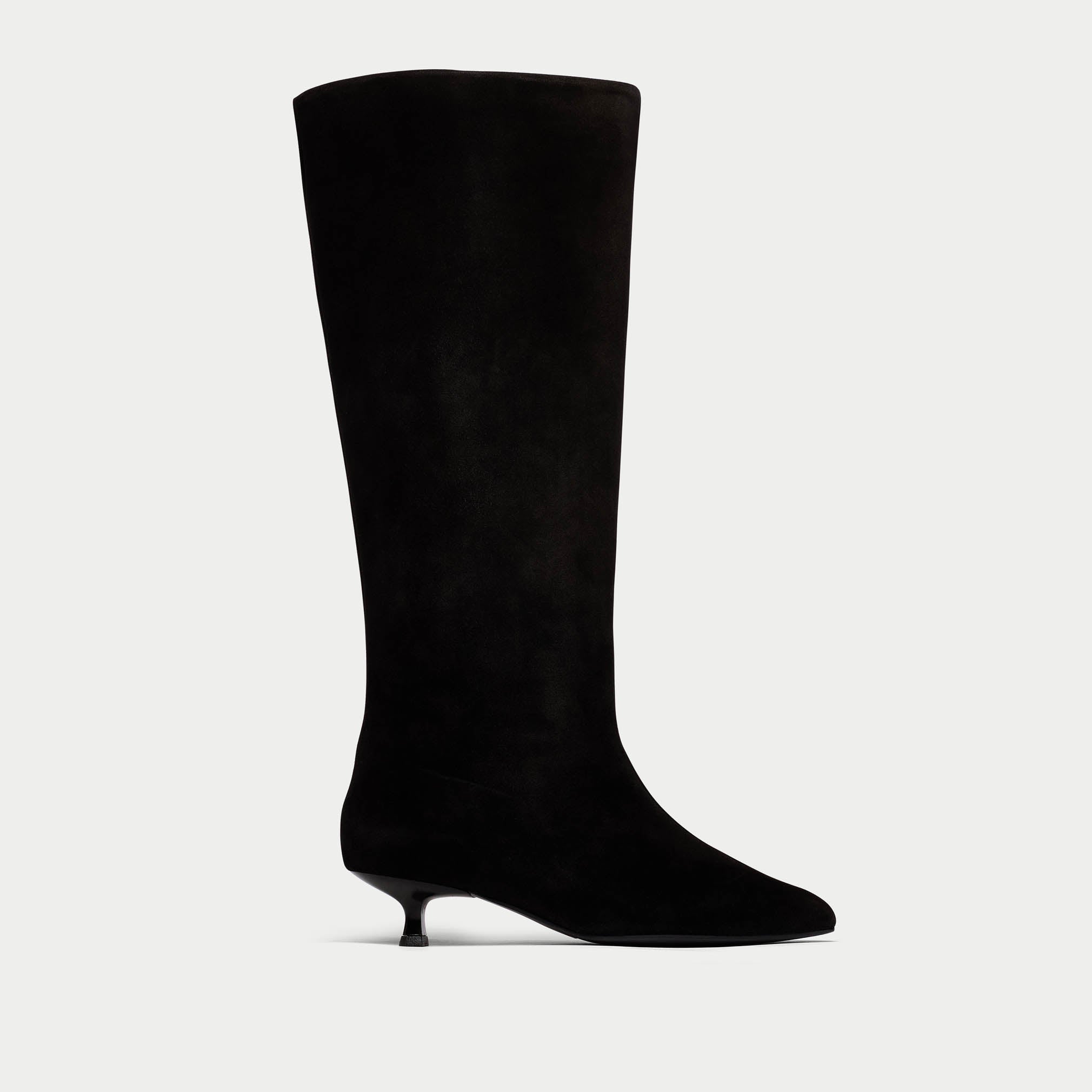 Black knee-high boot on a light gray background