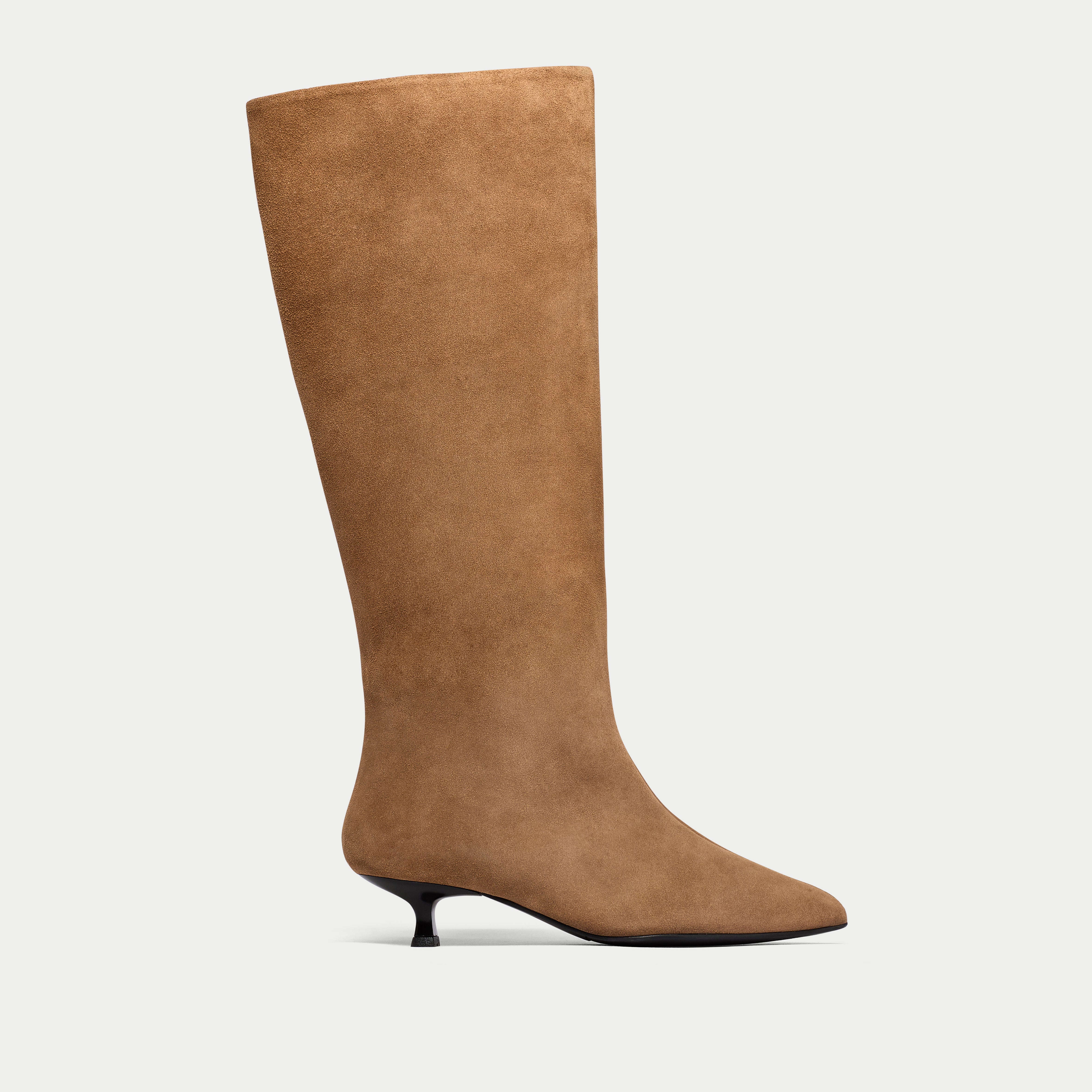 Tan knee-high boot on a light gray background