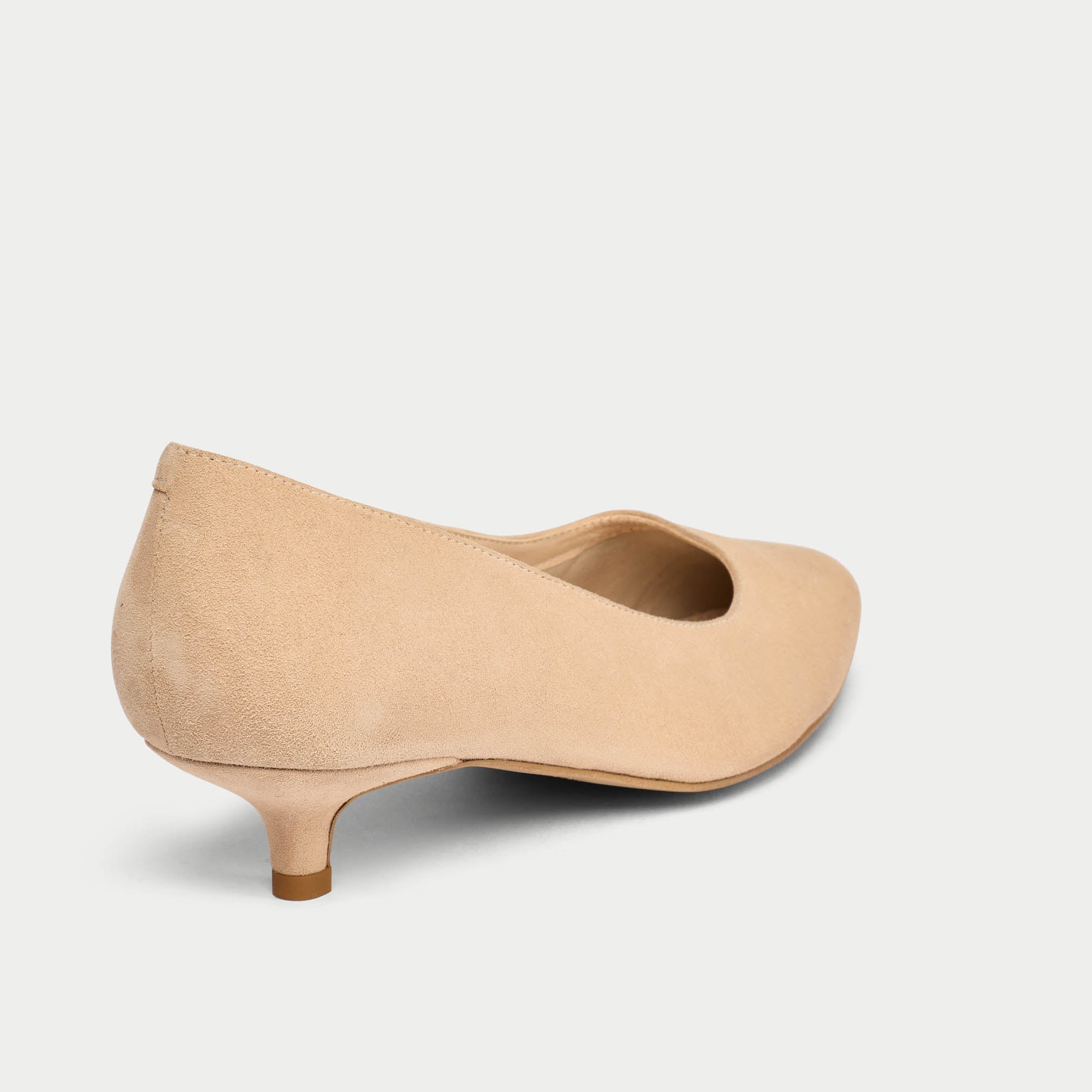Beige kitten heel shoe on a light gray background