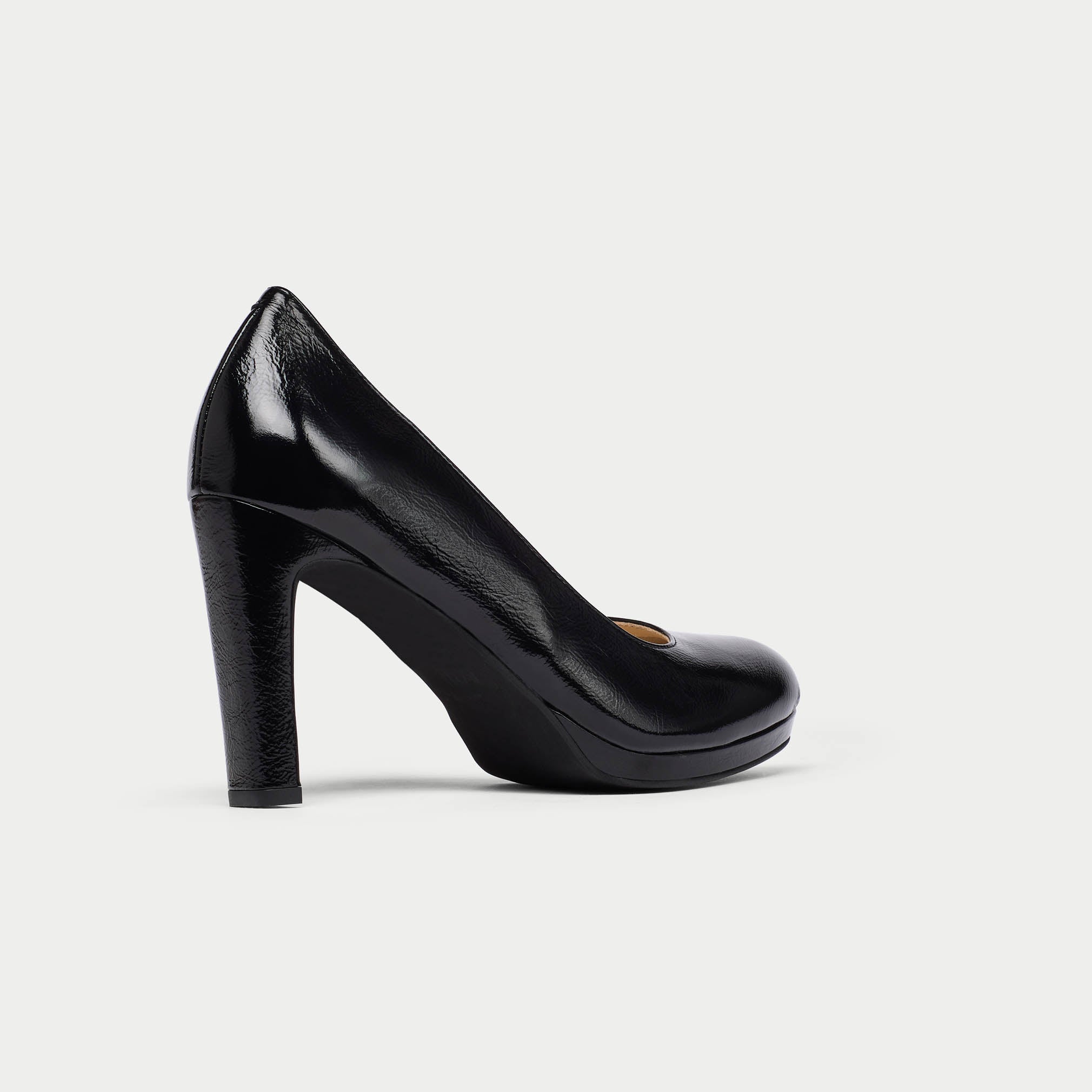 Black high-heeled shoe on a light gray background