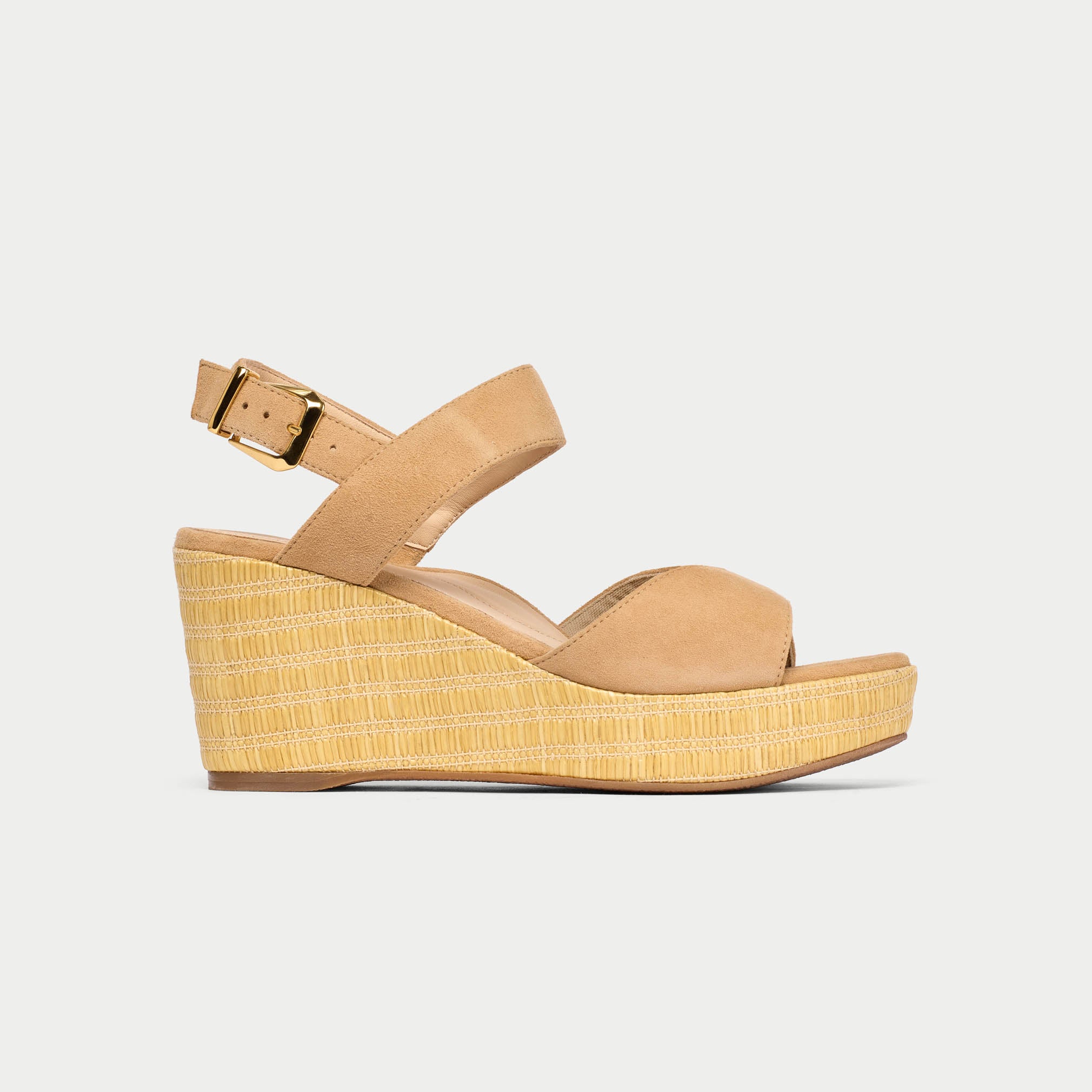 Tan wedge sandal with a woven platform on a light gray background