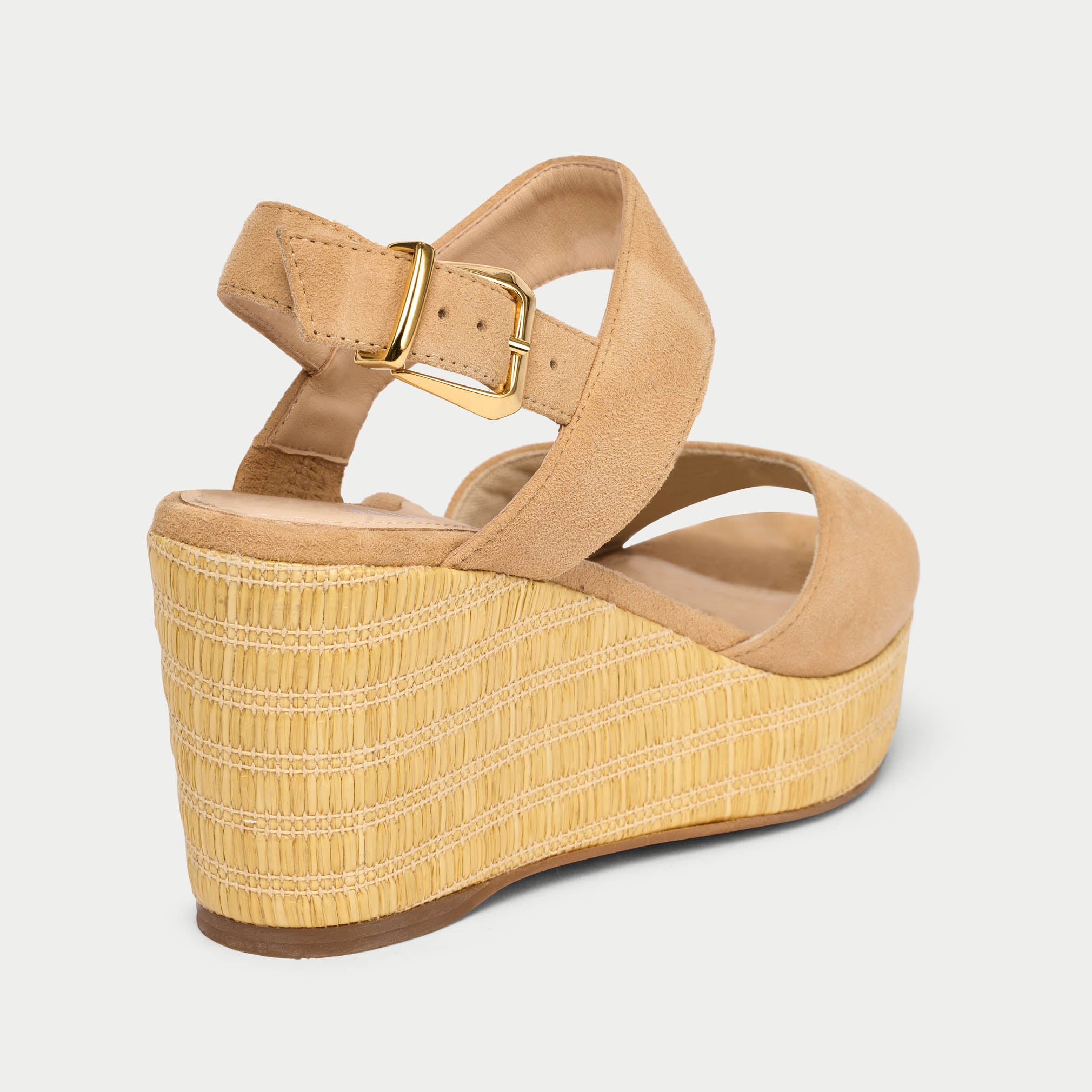 Beige wedge sandal with a strap on a light gray background