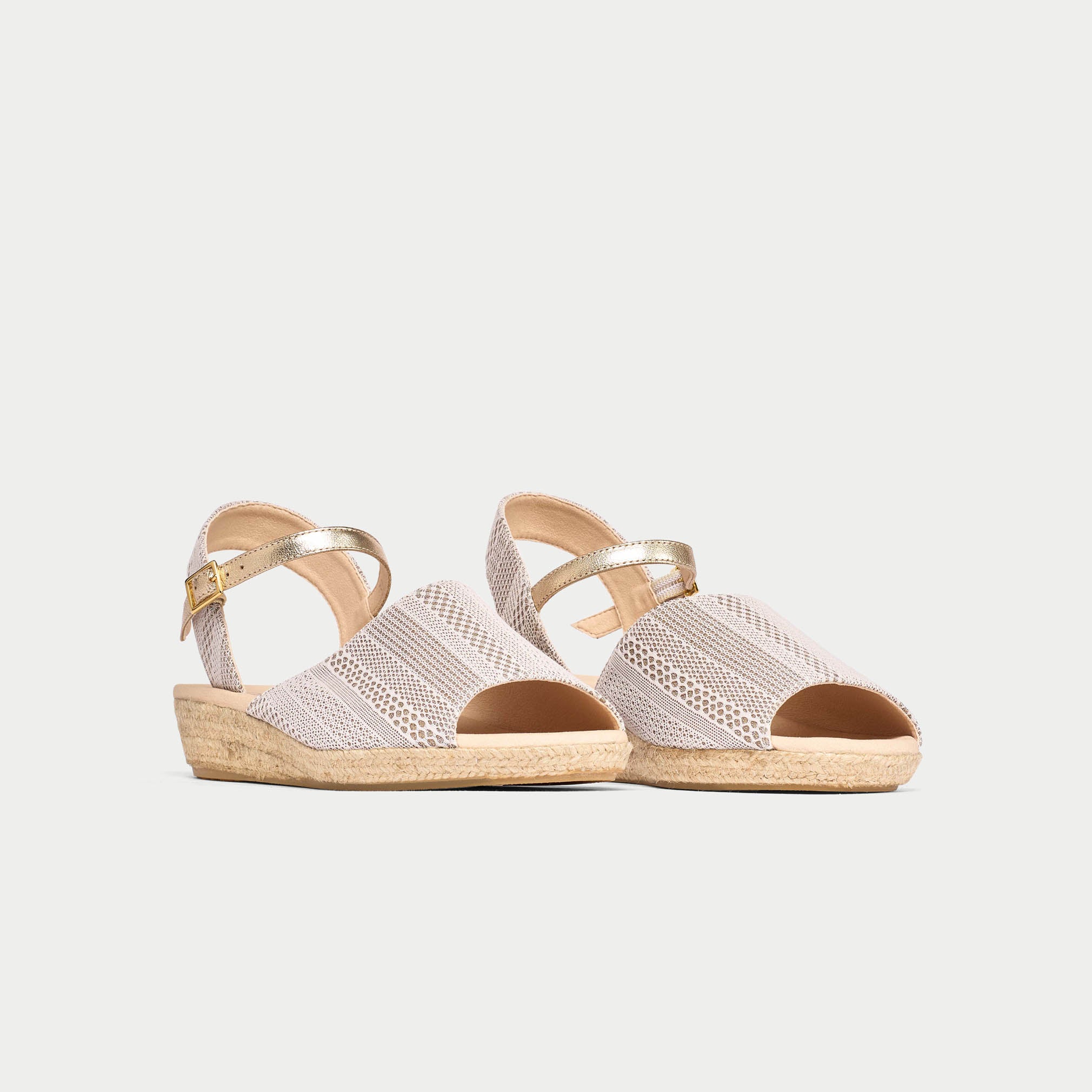 Pair of sandals with mesh design and wooden sole on a light gray background