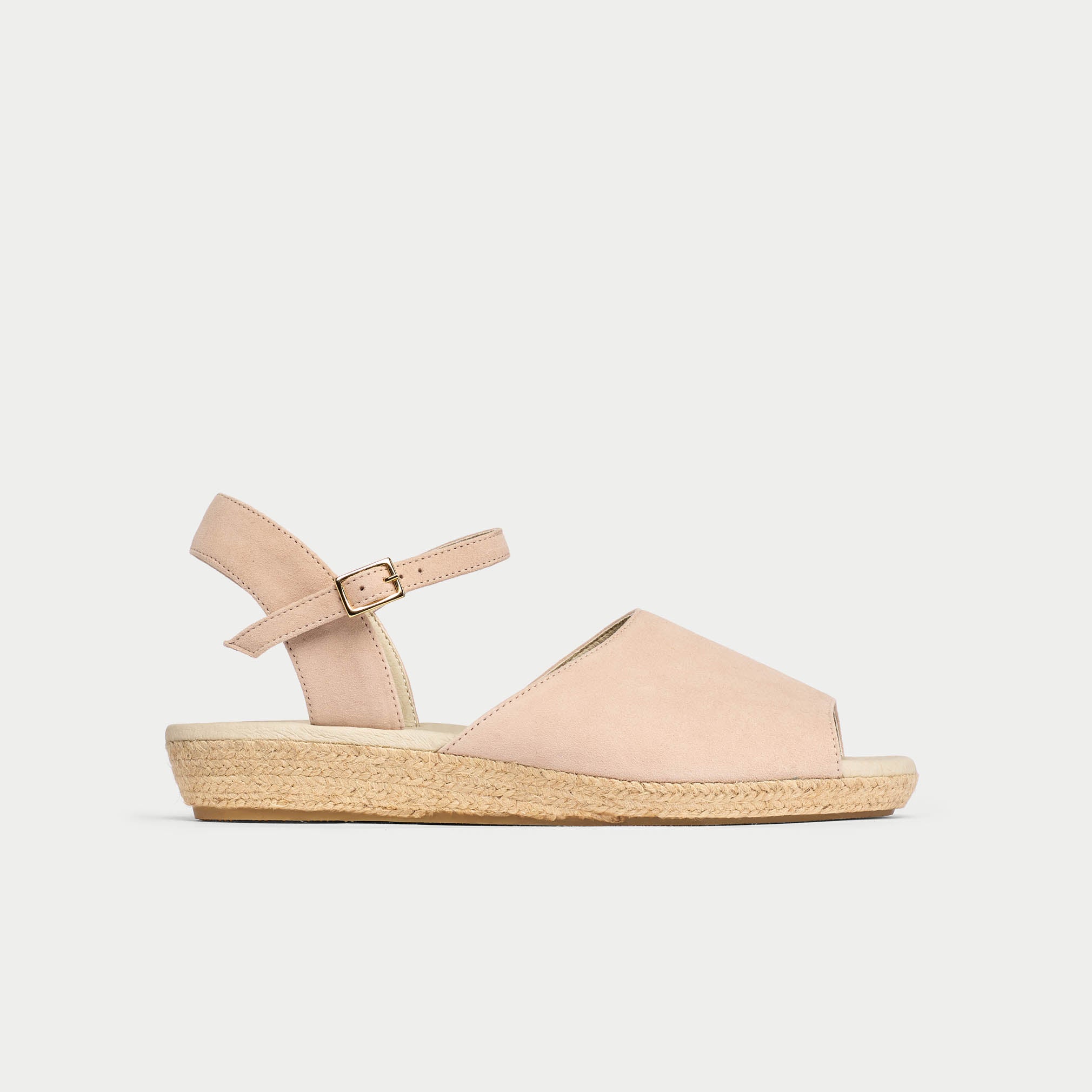 Beige sandal with a wedge sole on a light gray background