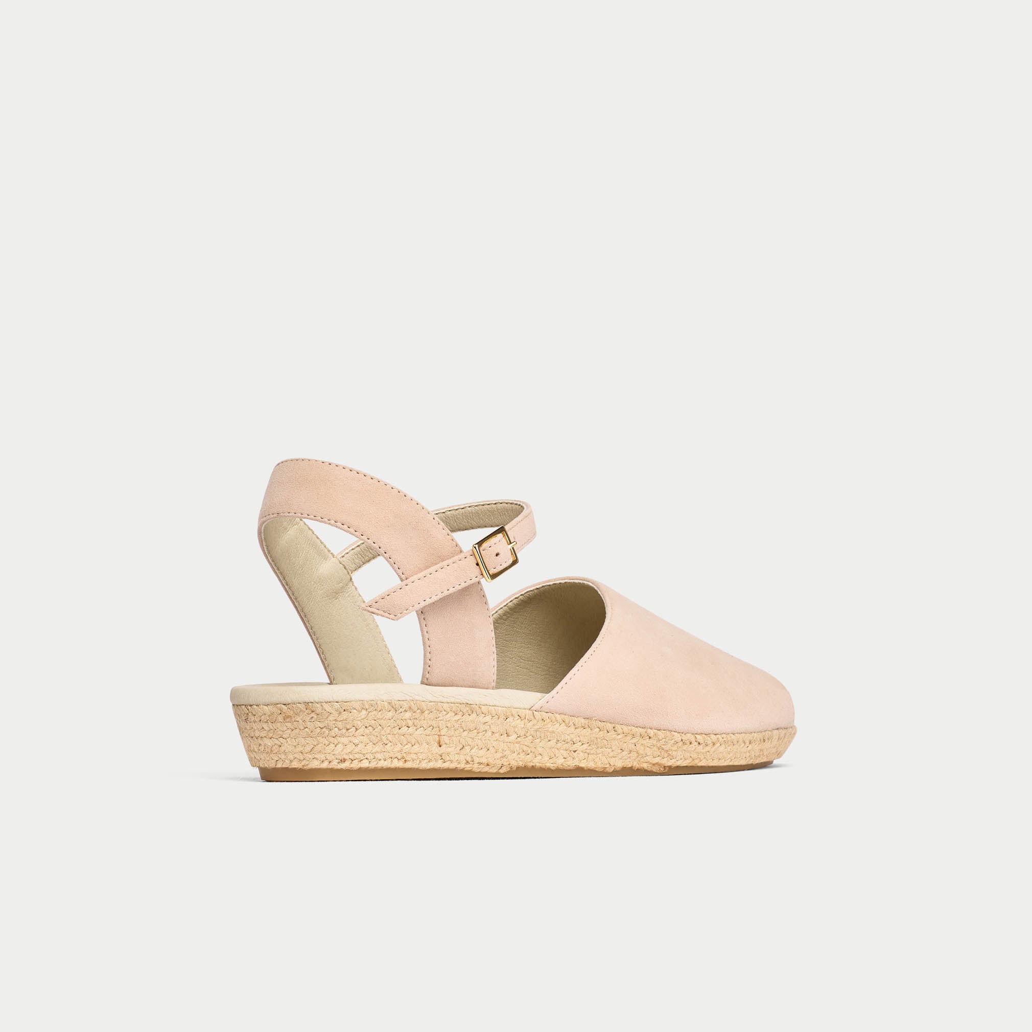 Pink sandal with a jute sole on a light gray background