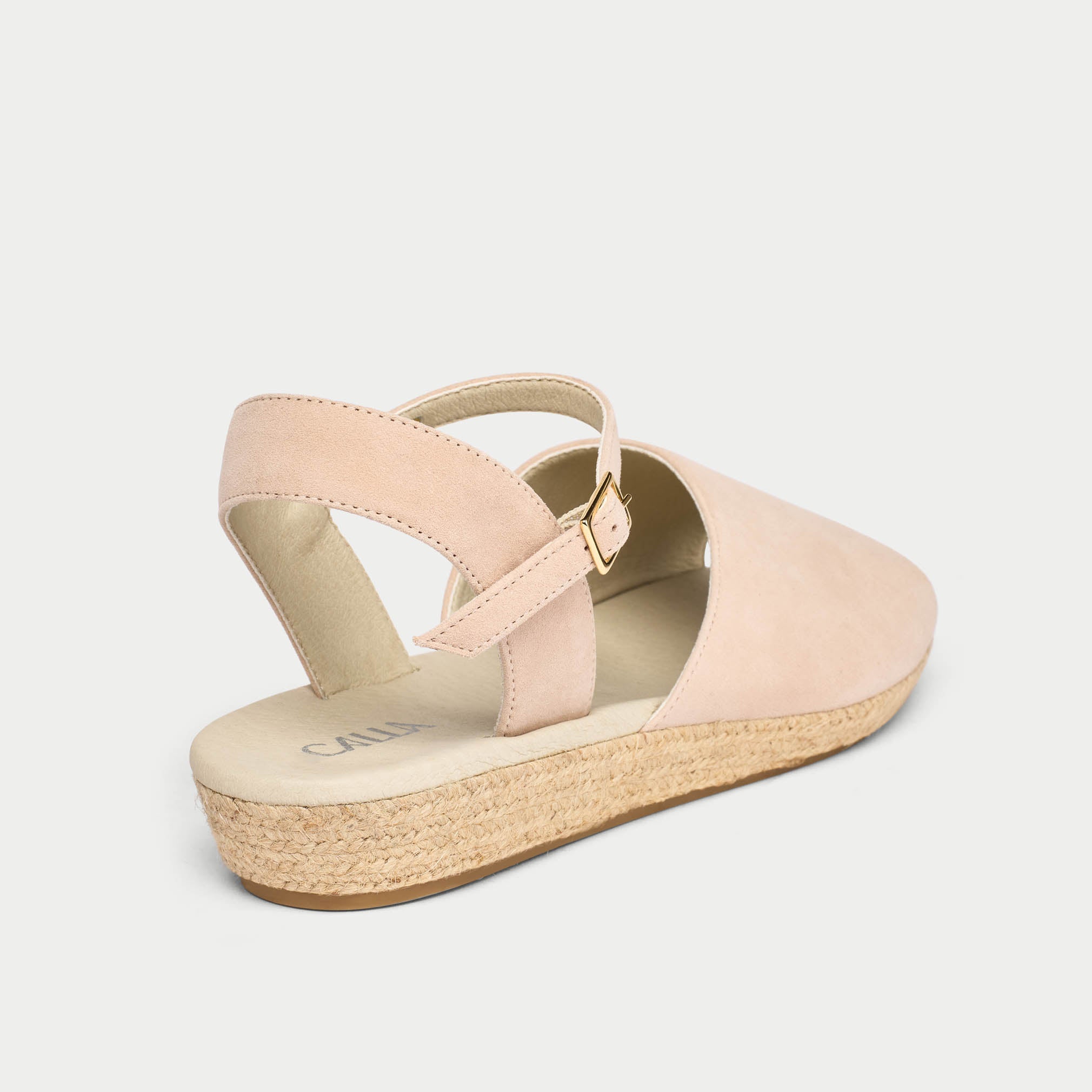 Pink wedge sandal with a jute sole on a light gray background
